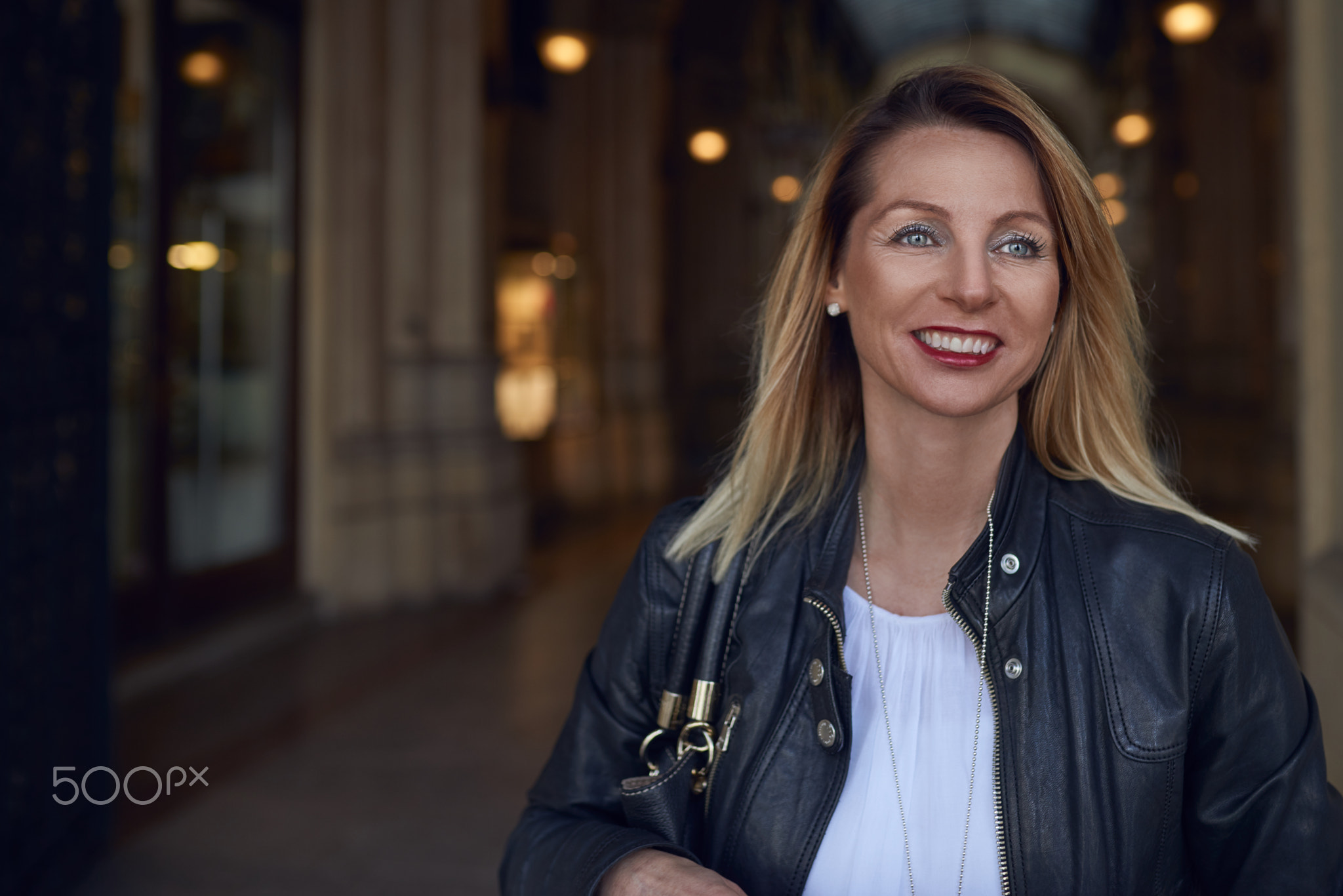 Attractive trendy woman walking through an arcade