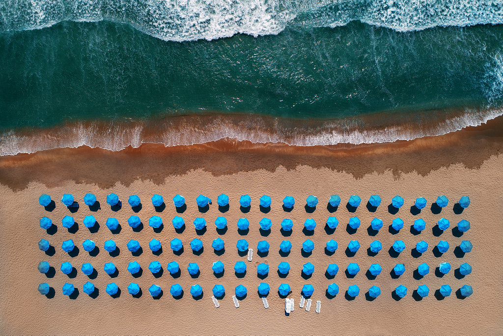 Aerial top view on the beach. Umbrellas, sand and sea waves by Valentin Valkov on 500px.com