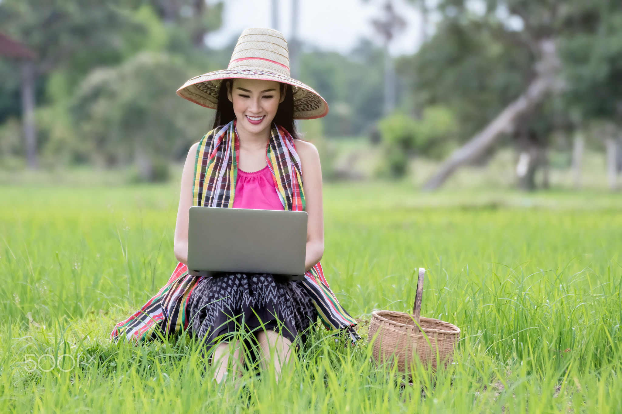 Beautiful asian woman working laptop outdoors
