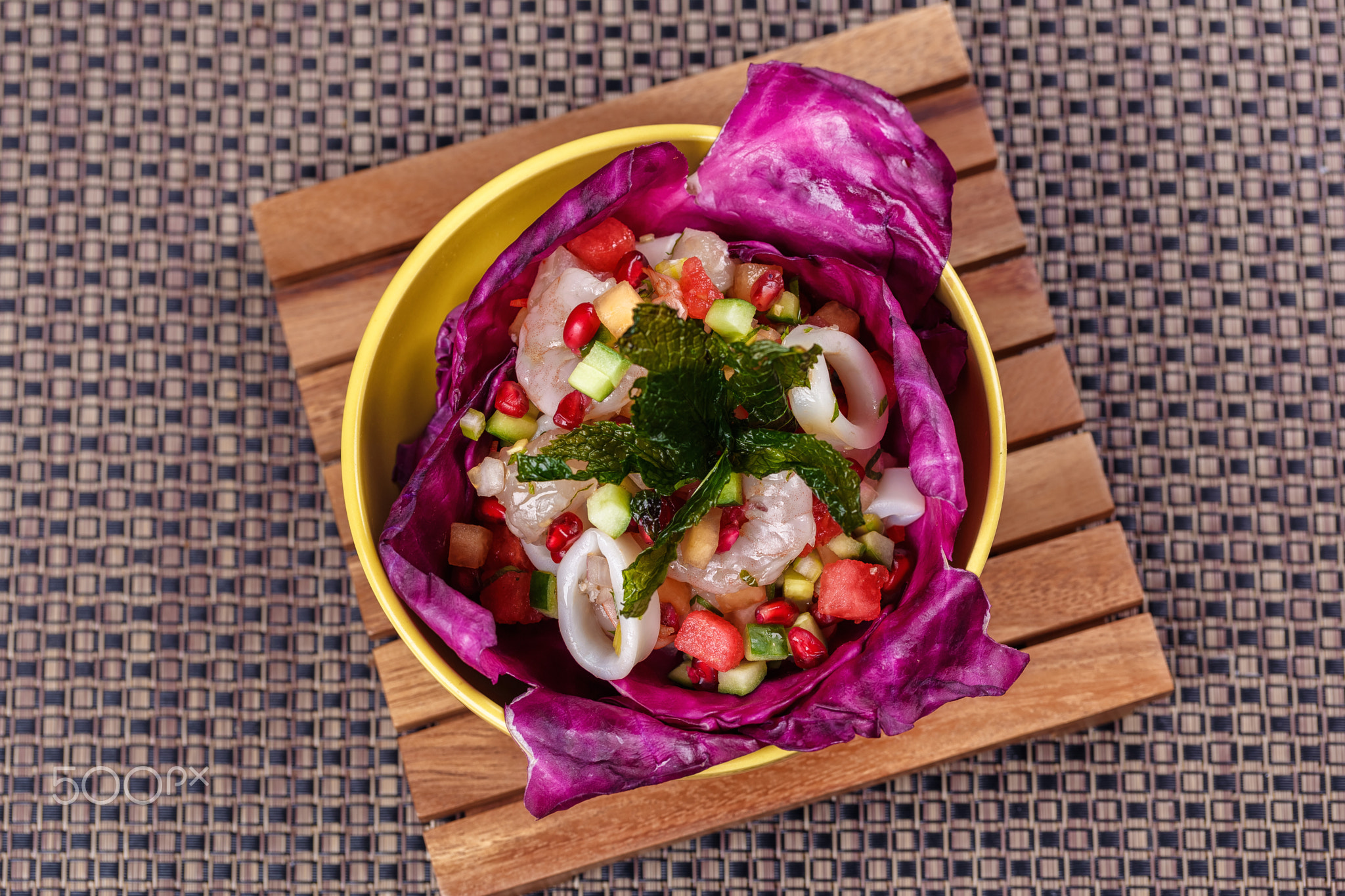 Vegetable salad with raw squid and shrimp.