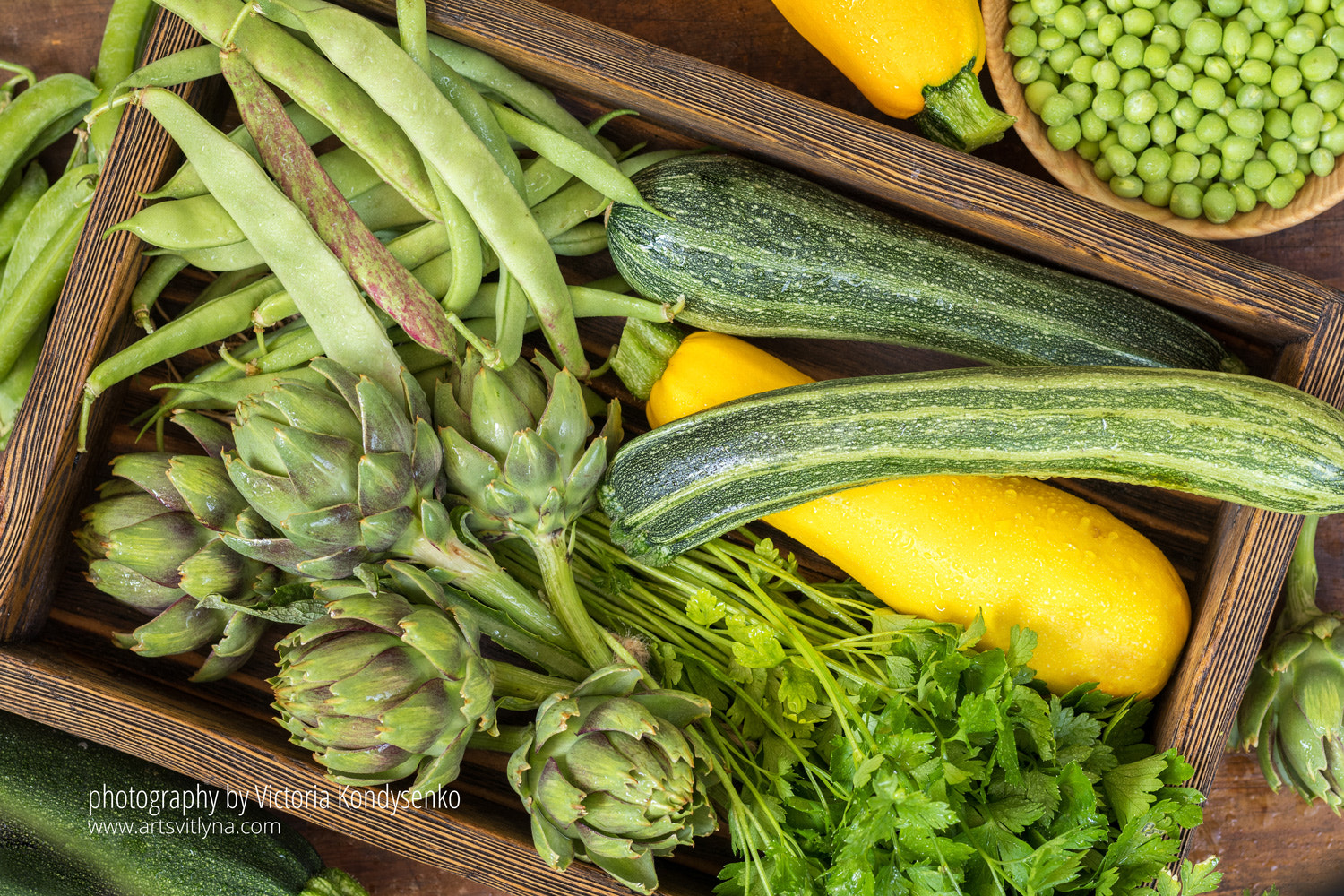 Fresh organic green vegetables on wooden floor