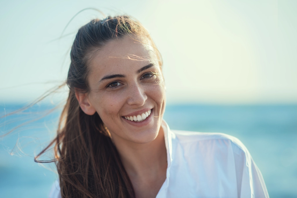 Young smiling girl at the beach by Igor Milic / 500px