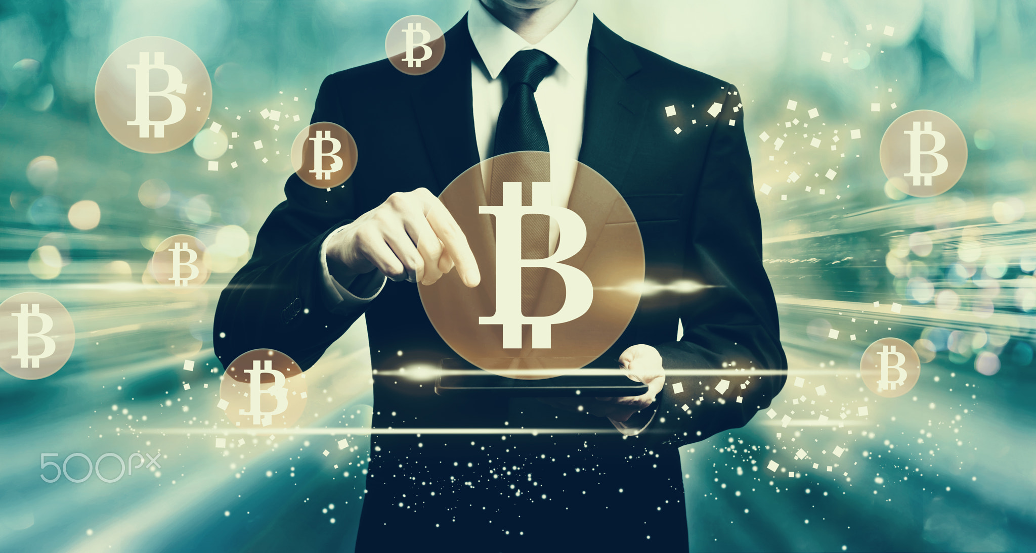 Bitcoins with man holding a tablet