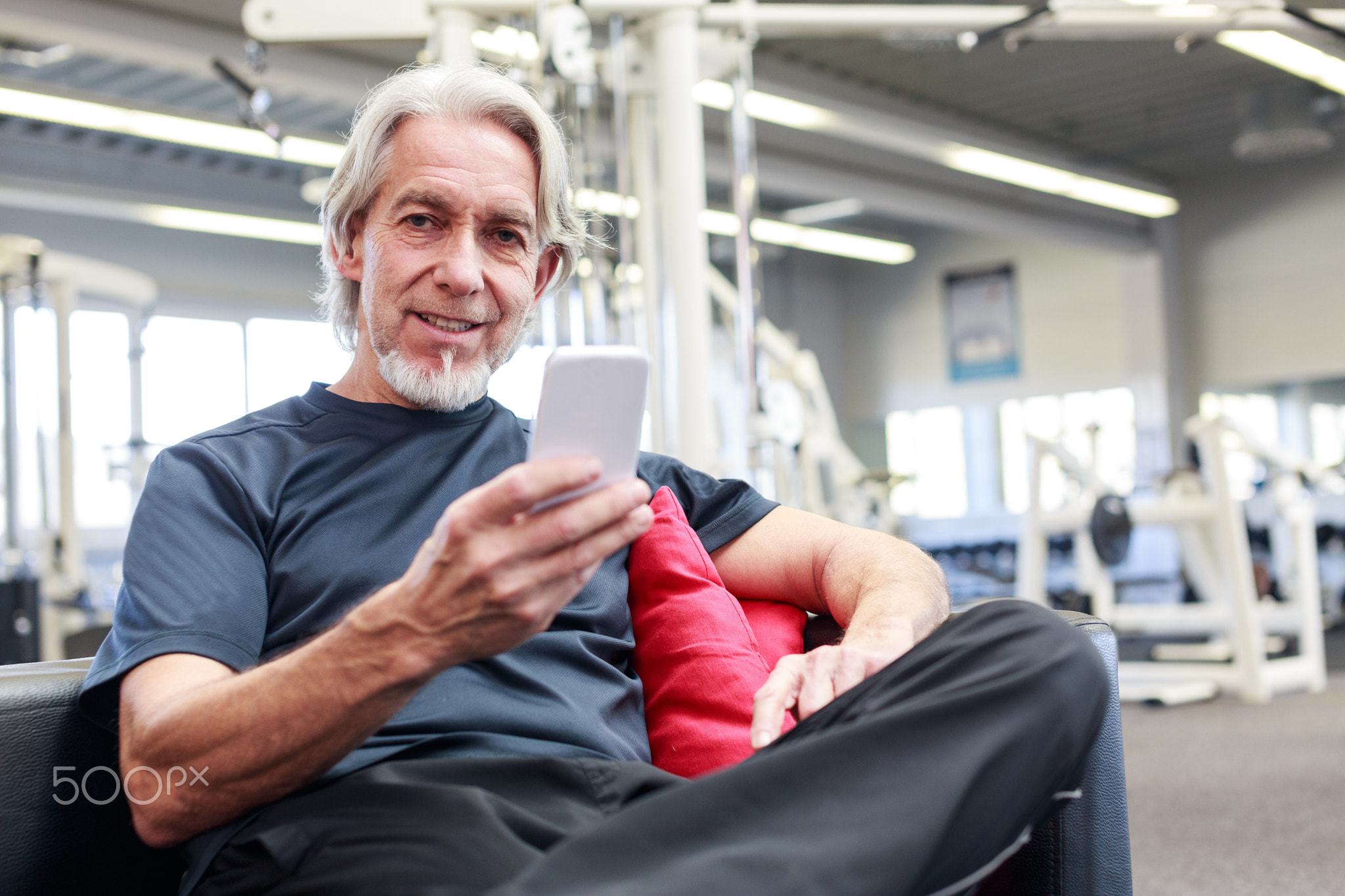 Senior Caucasian Man At The Gym, Checking His Phone