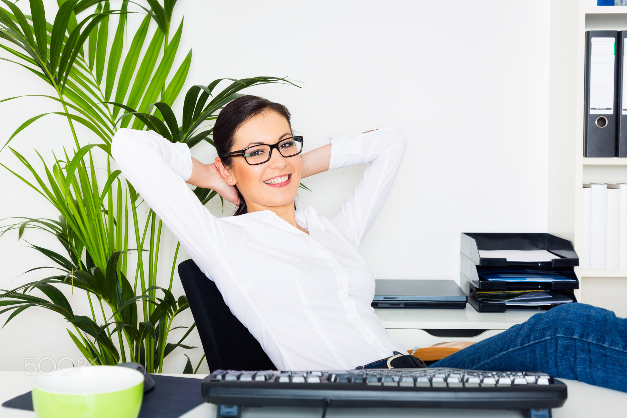 Young Woman Relaxing In Her Office