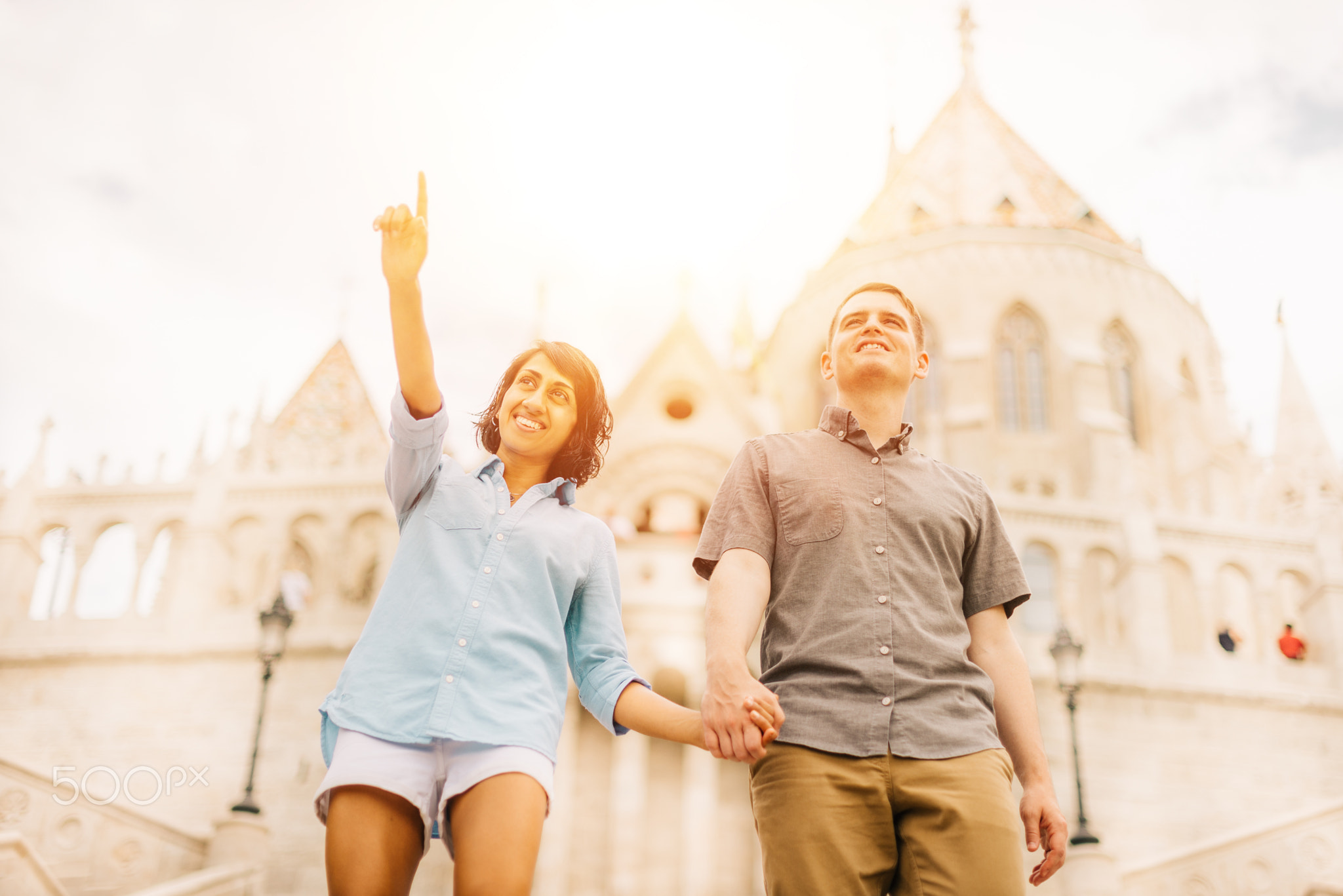 Multicultural Happy Couple Tourists Walking Down The Street Holding Hands | Honey Moon