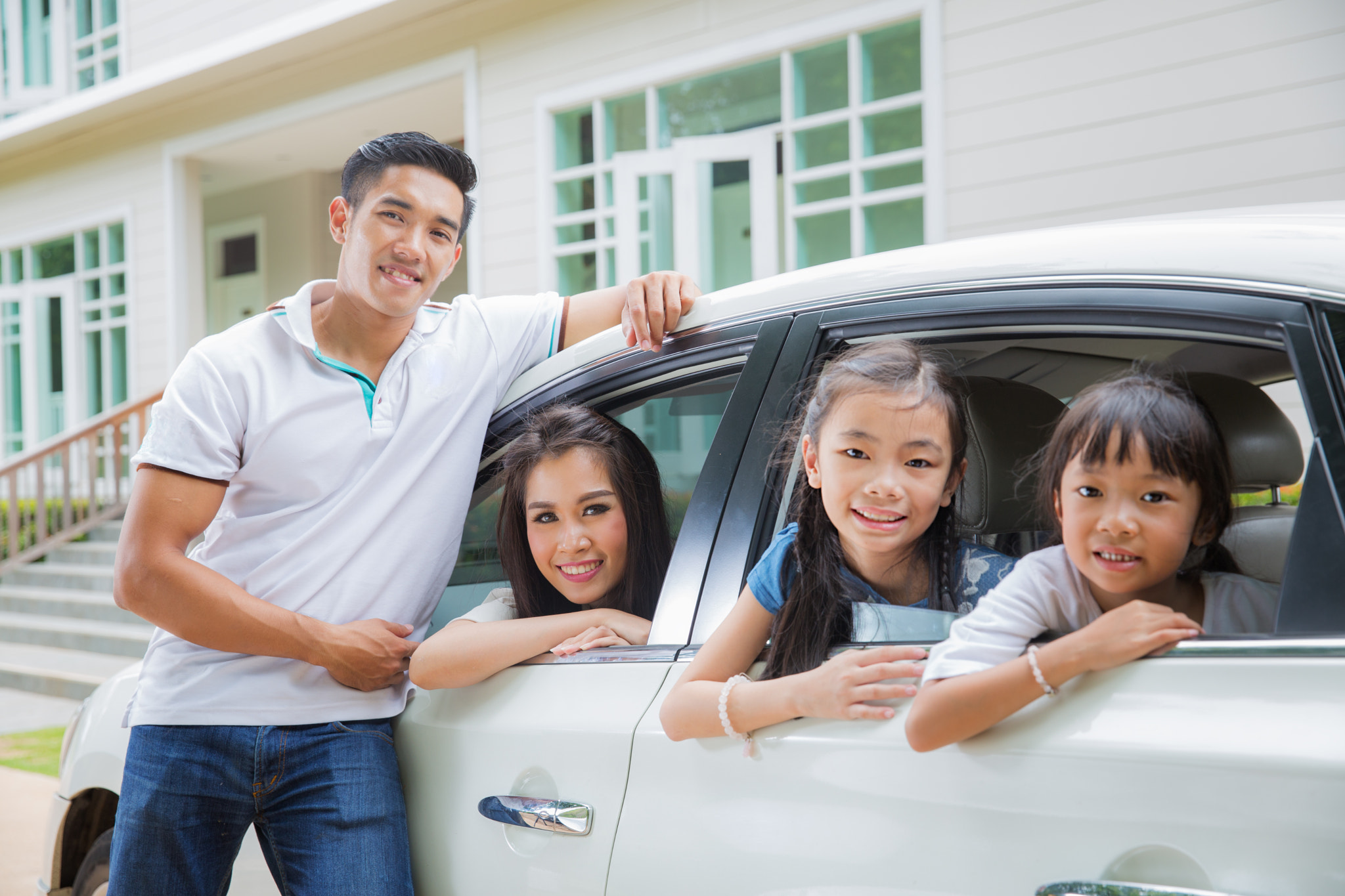 Beautiful family portrait smiling outside their new house