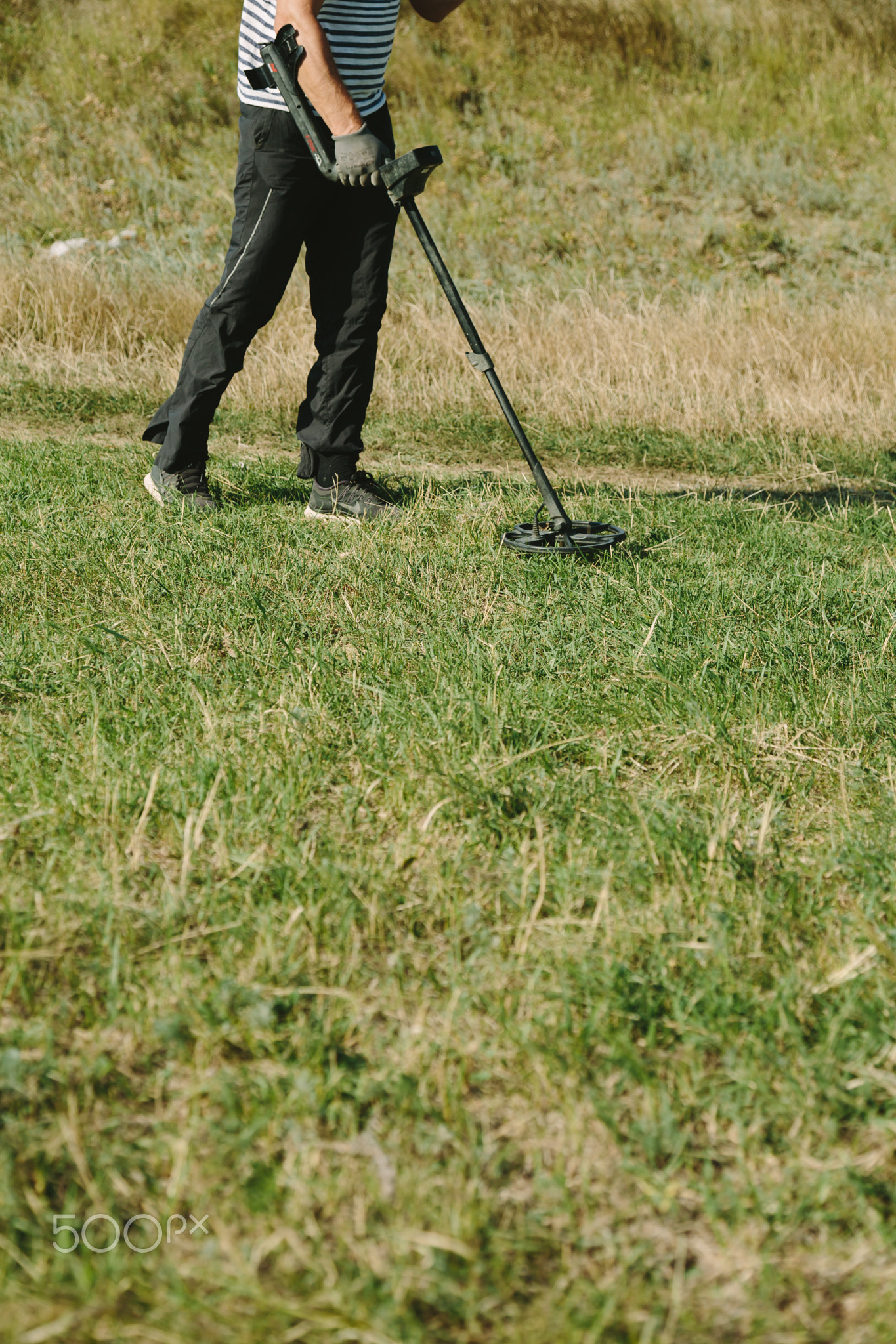 Person with metal finder on nature