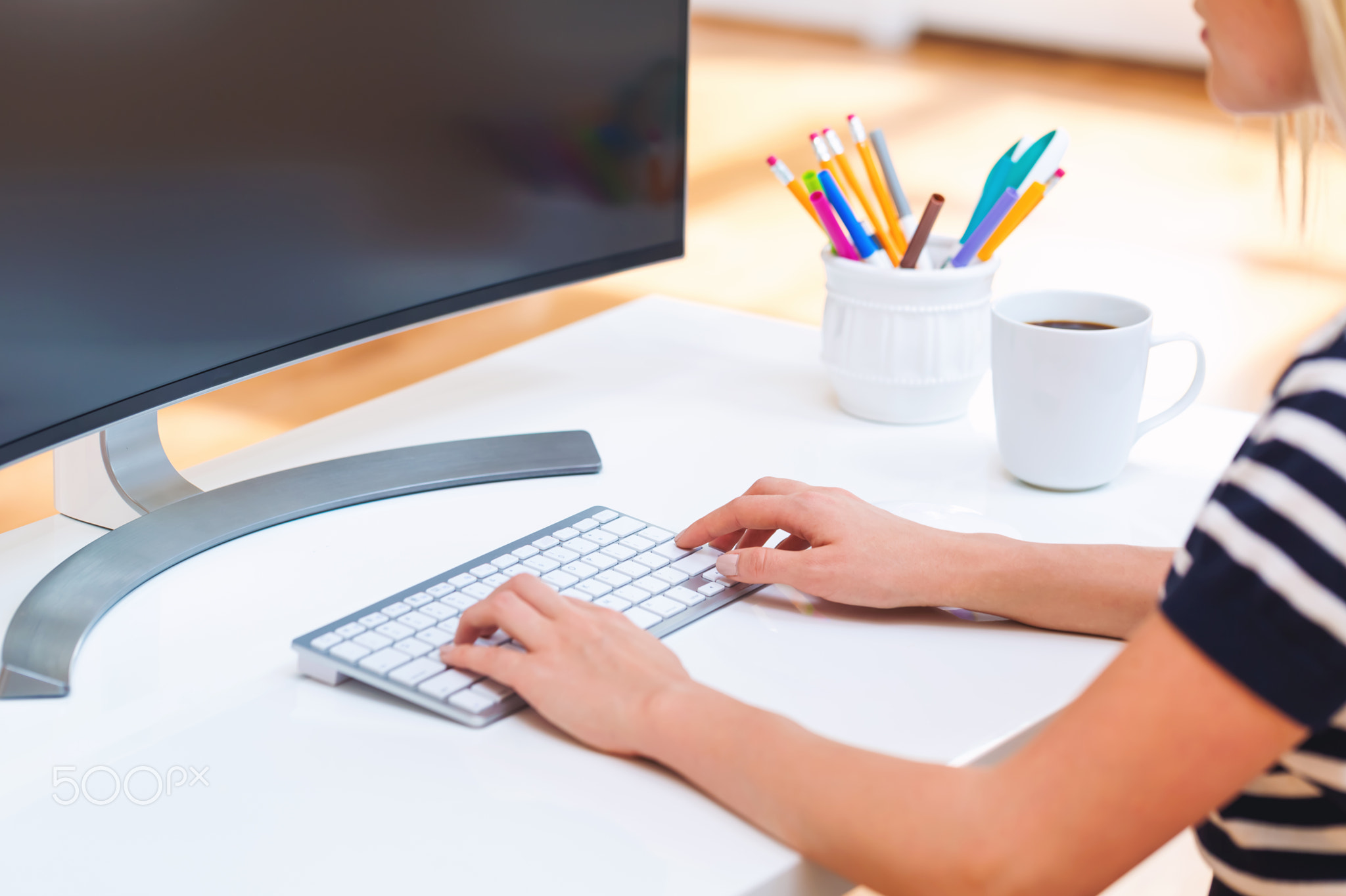 Person typing at on her office computer