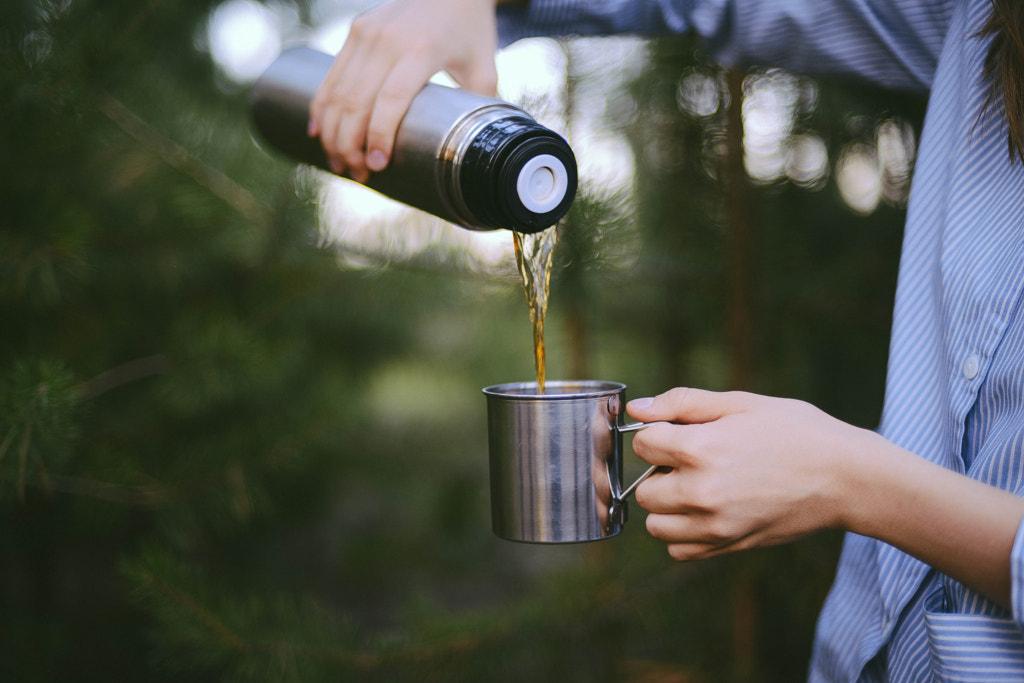 Traveler girl pouring tea from thermos cup, outdoo by INNA CHERNYSH on 500px.com