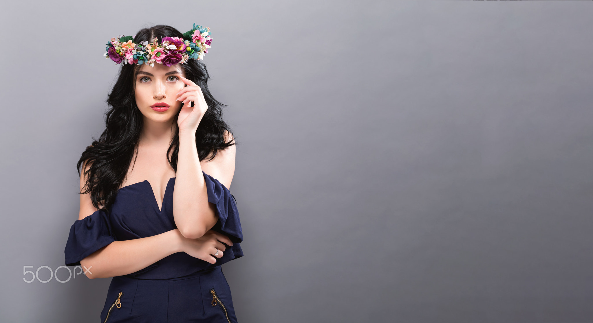 Beautiful young woman with a garland