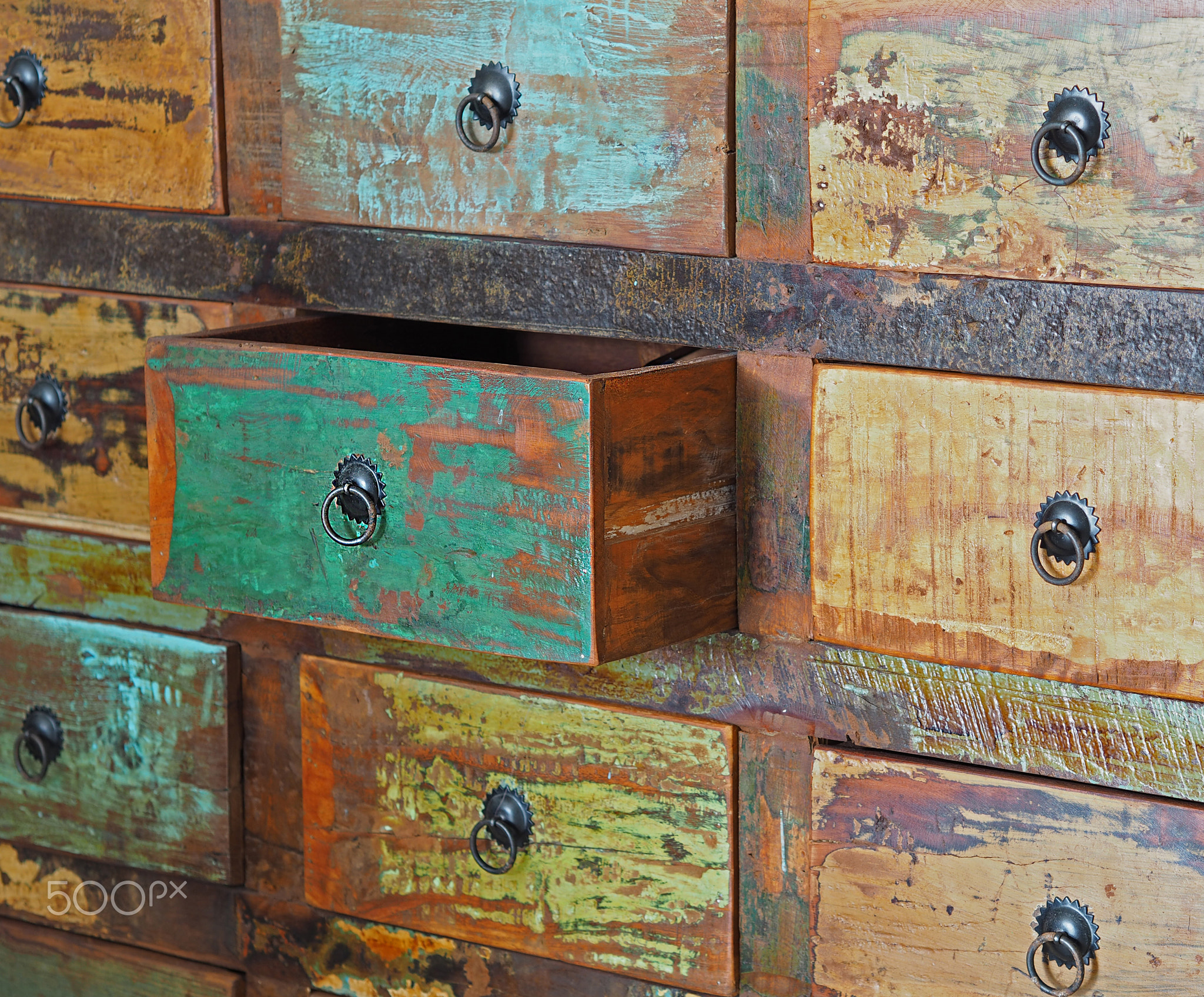 pulled drawer on old wooden colorful dresser