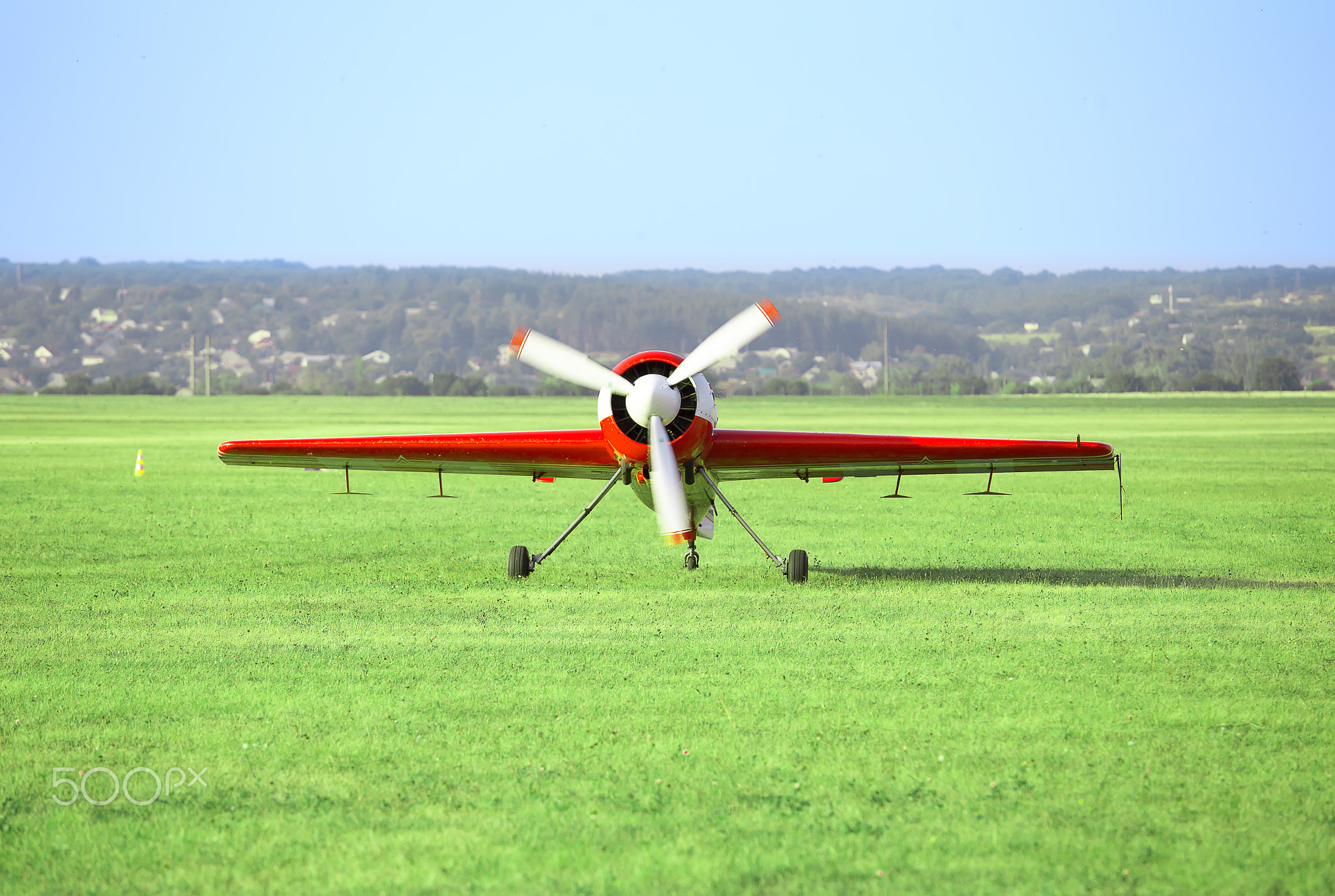 Red white airplane on the airfield