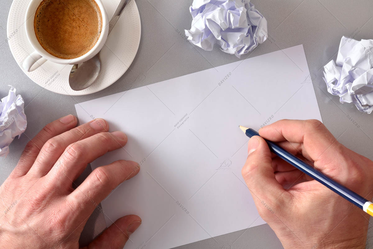 Worker developing an idea on his workbench top view