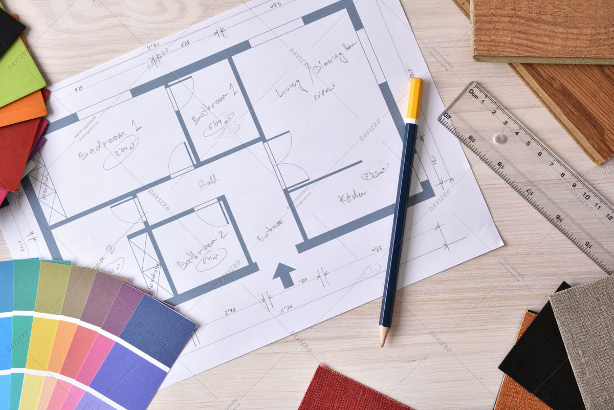 Decorator workbench with home plan on wooden table top