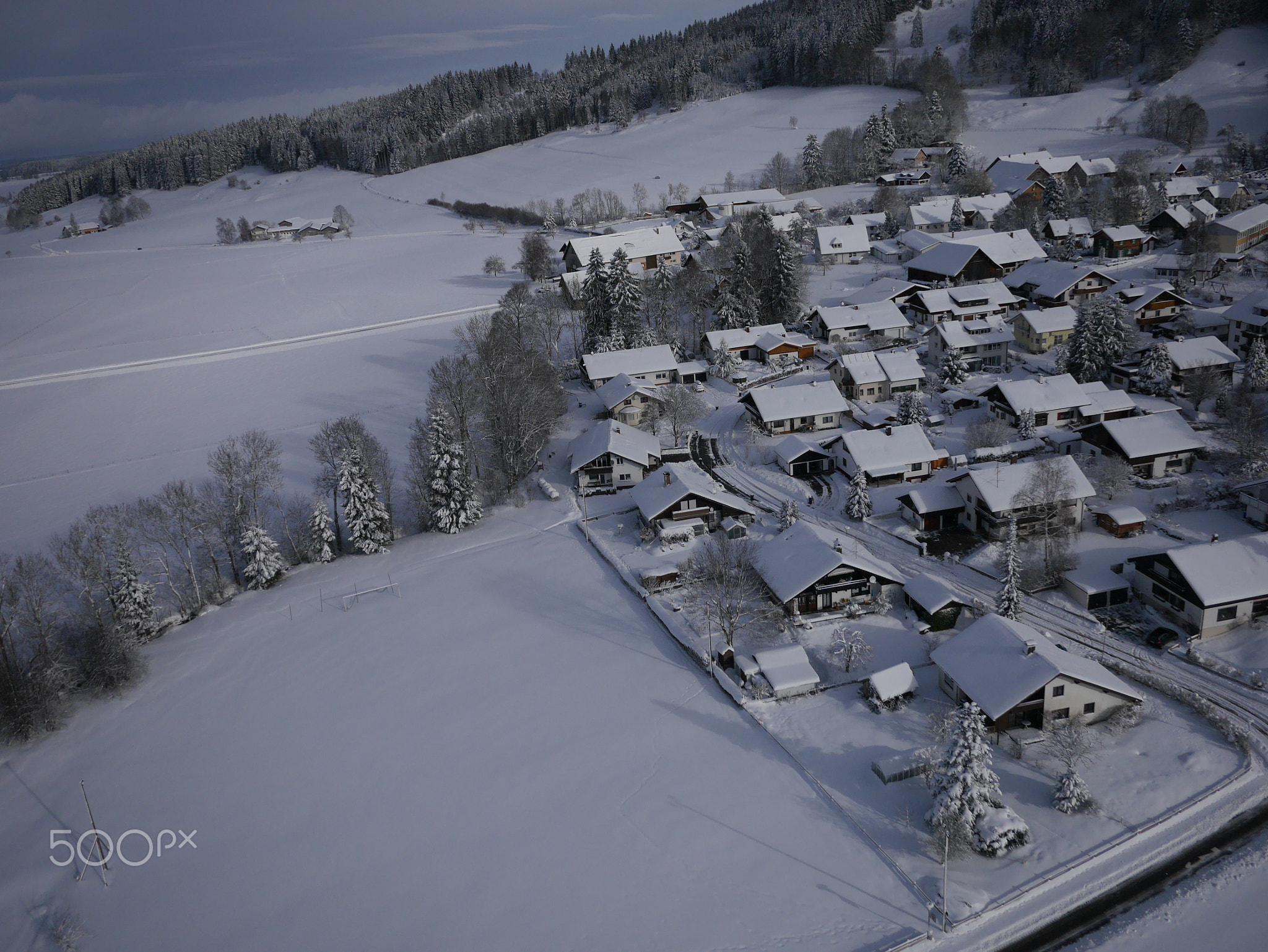 aerial photo of village in winter