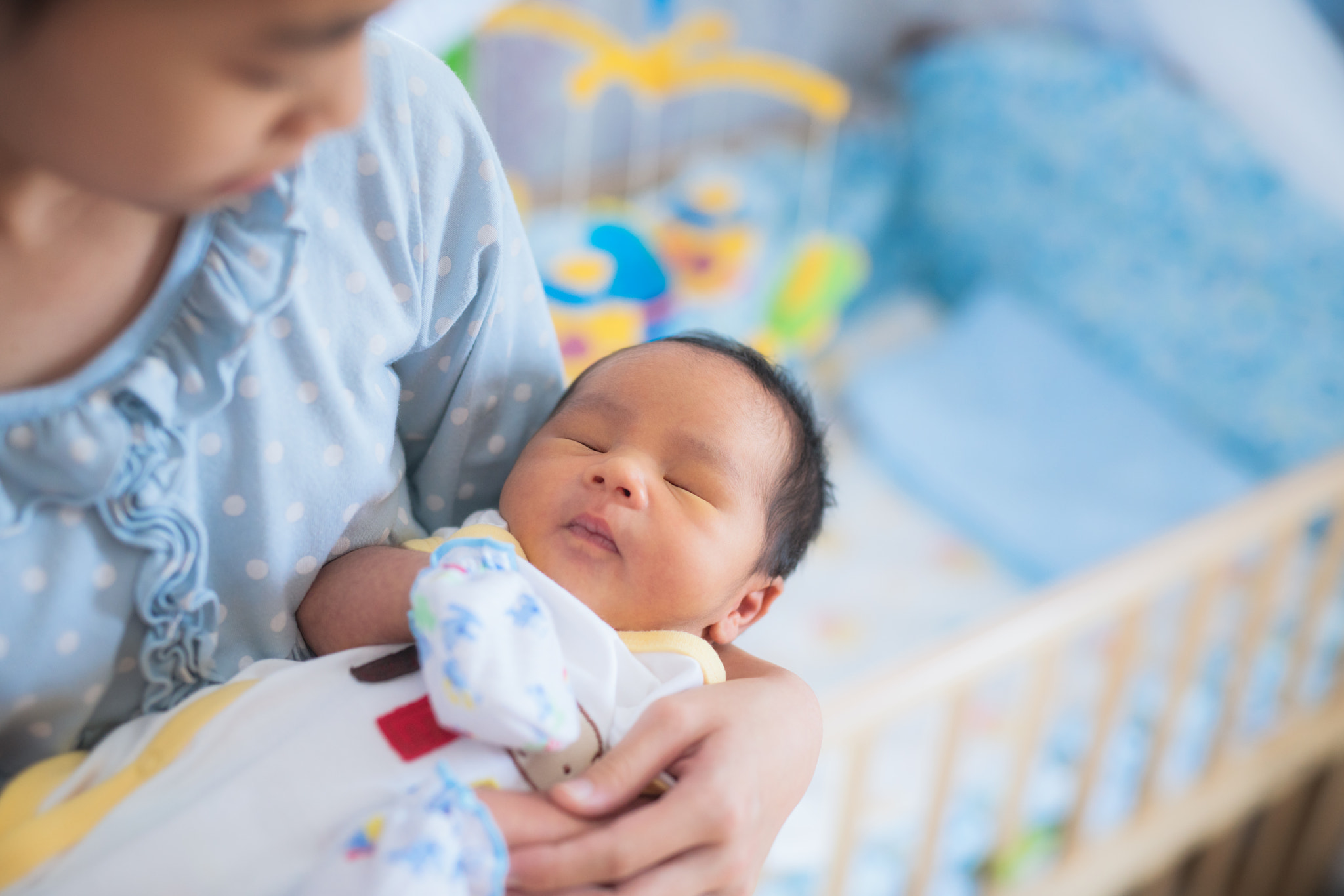 Sister takecare asian new born baby to sleep