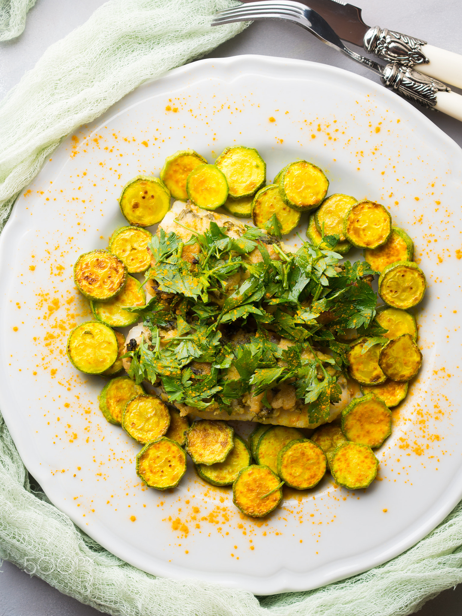 Stock fish fillet with turmeric courgettes