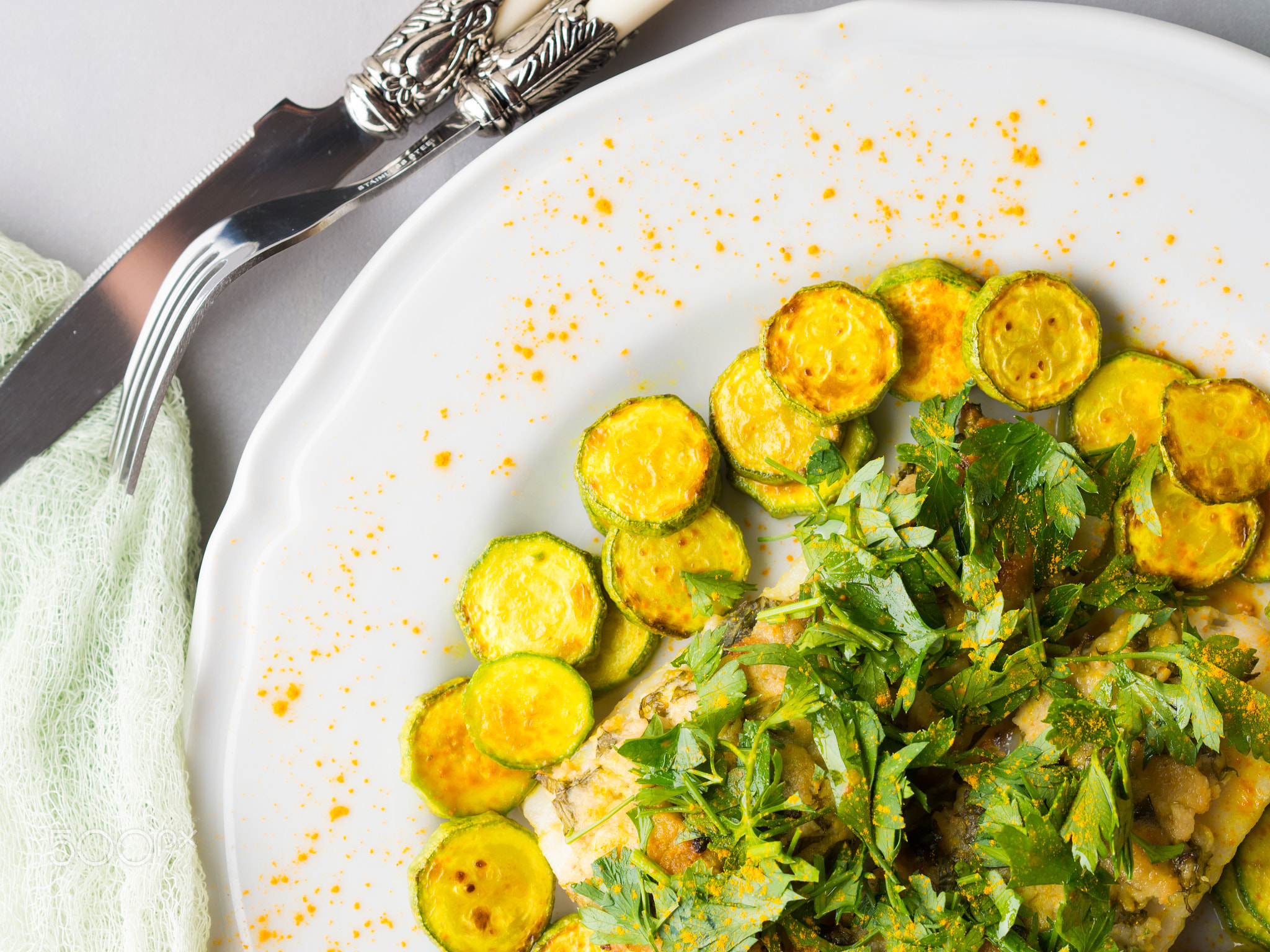 Stock fish fillet with turmeric courgettes