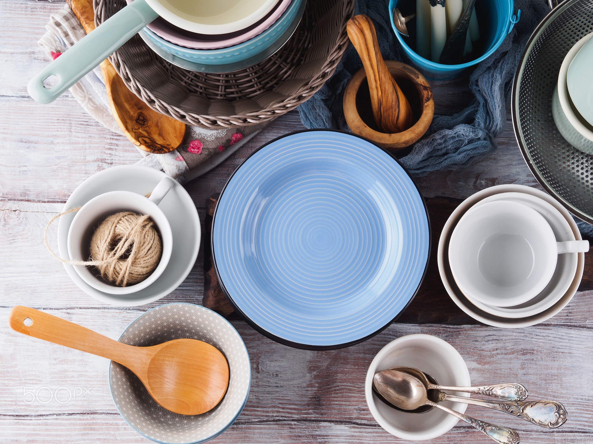 Ceramic and enamel crockery on wooden background