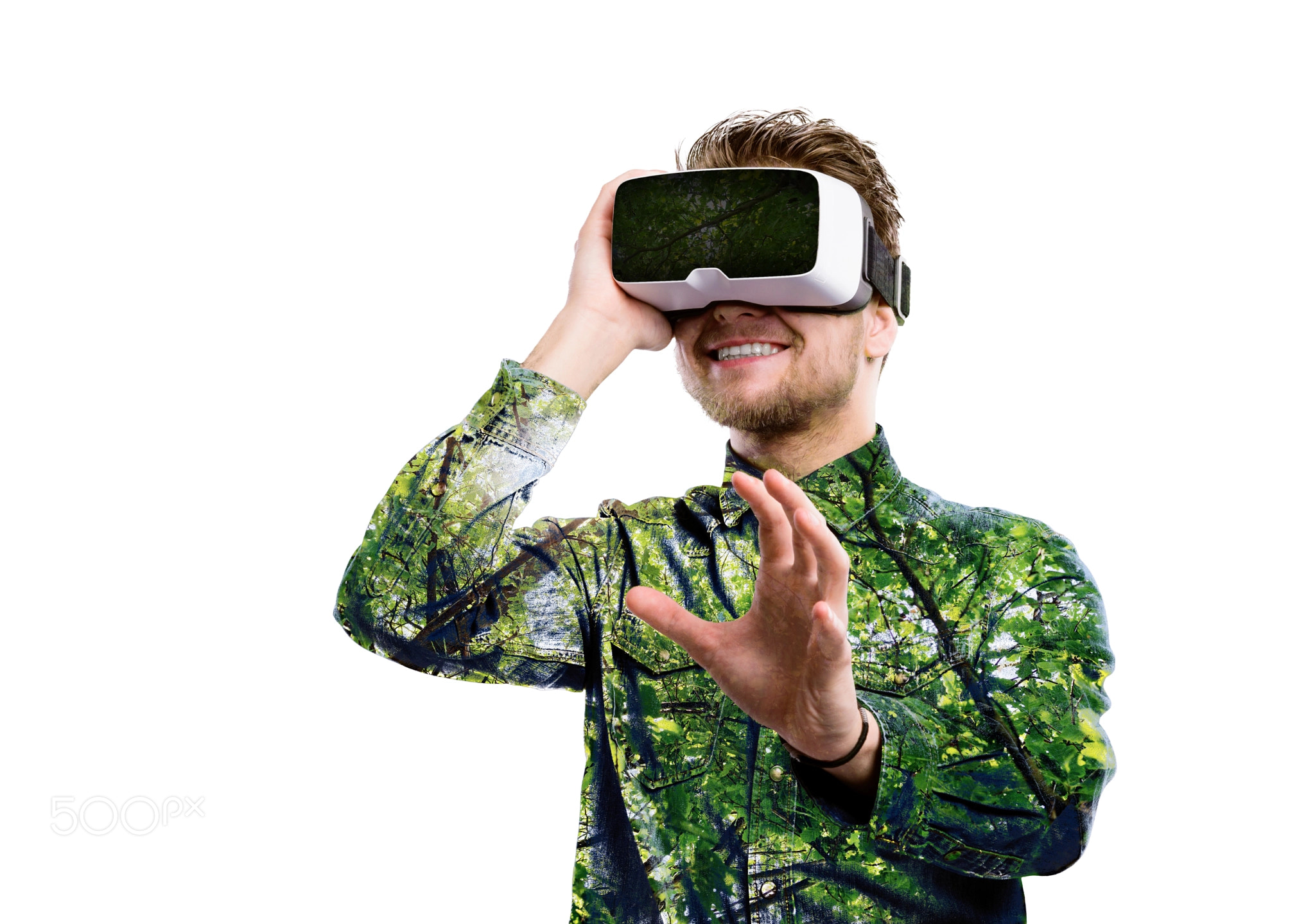 Double exposure. Man wearing virtual reality goggles. Trees.