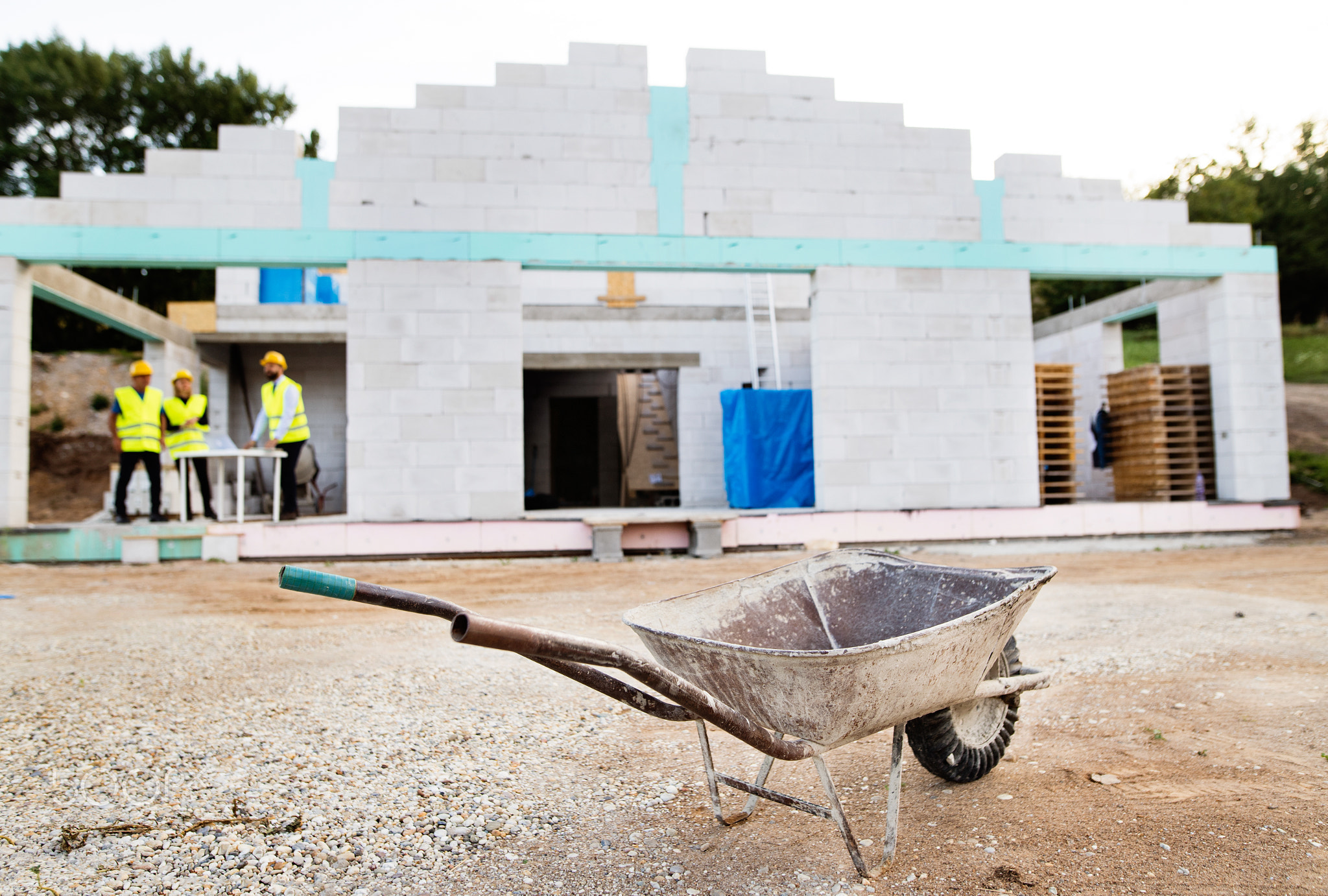 Architects and worker at the construction site.