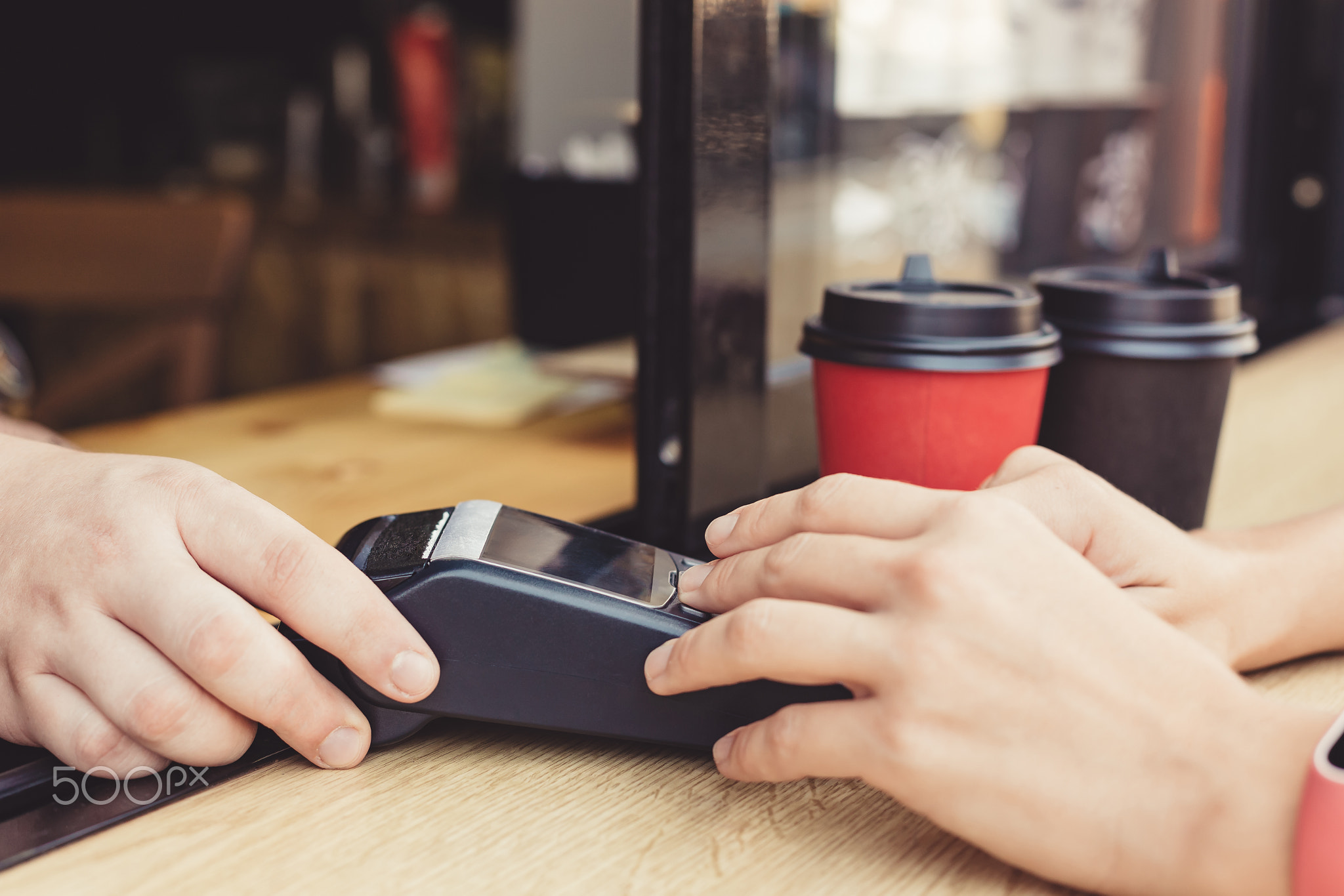 Person using pos terminal at the cafe