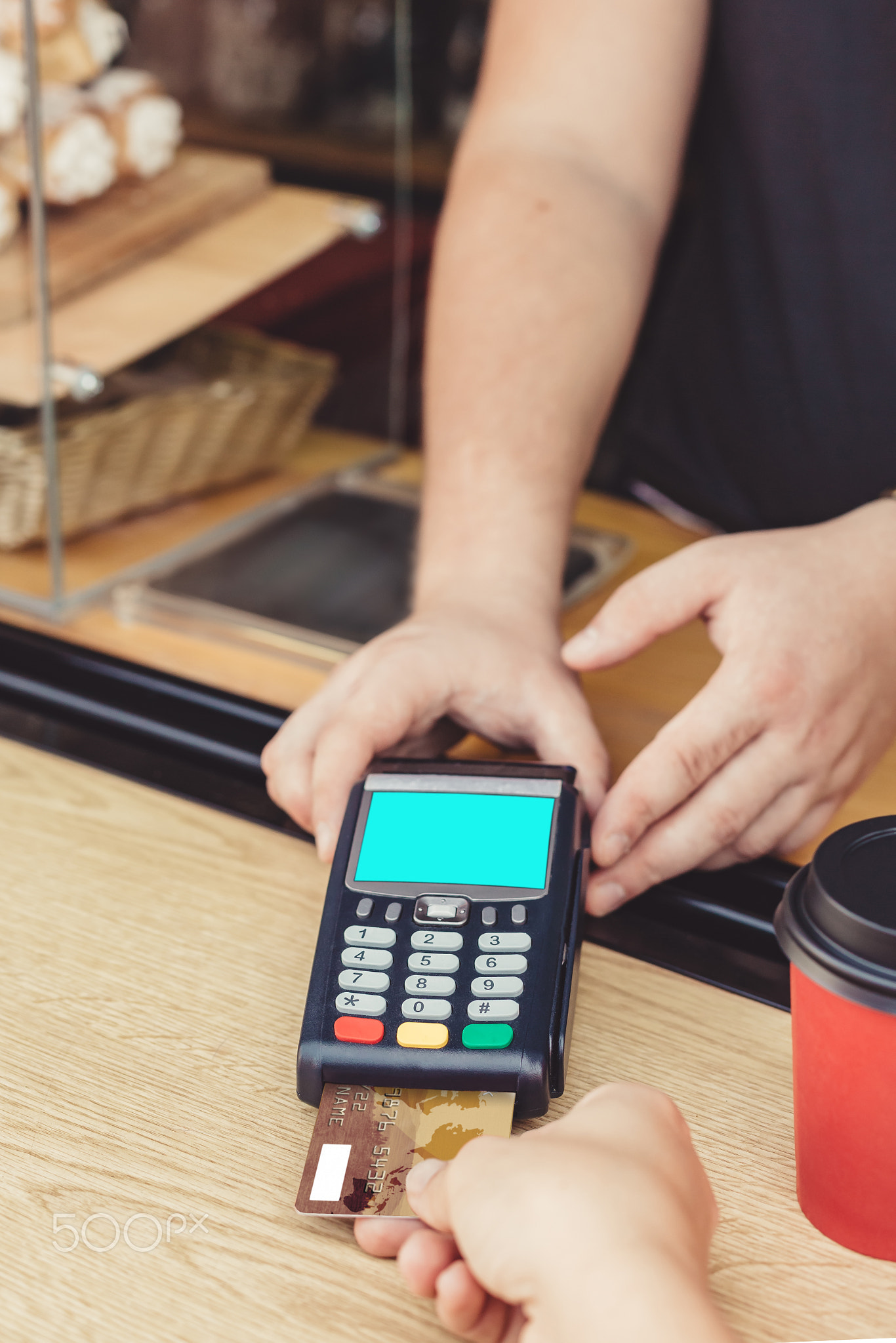 Person paying bill in cafe