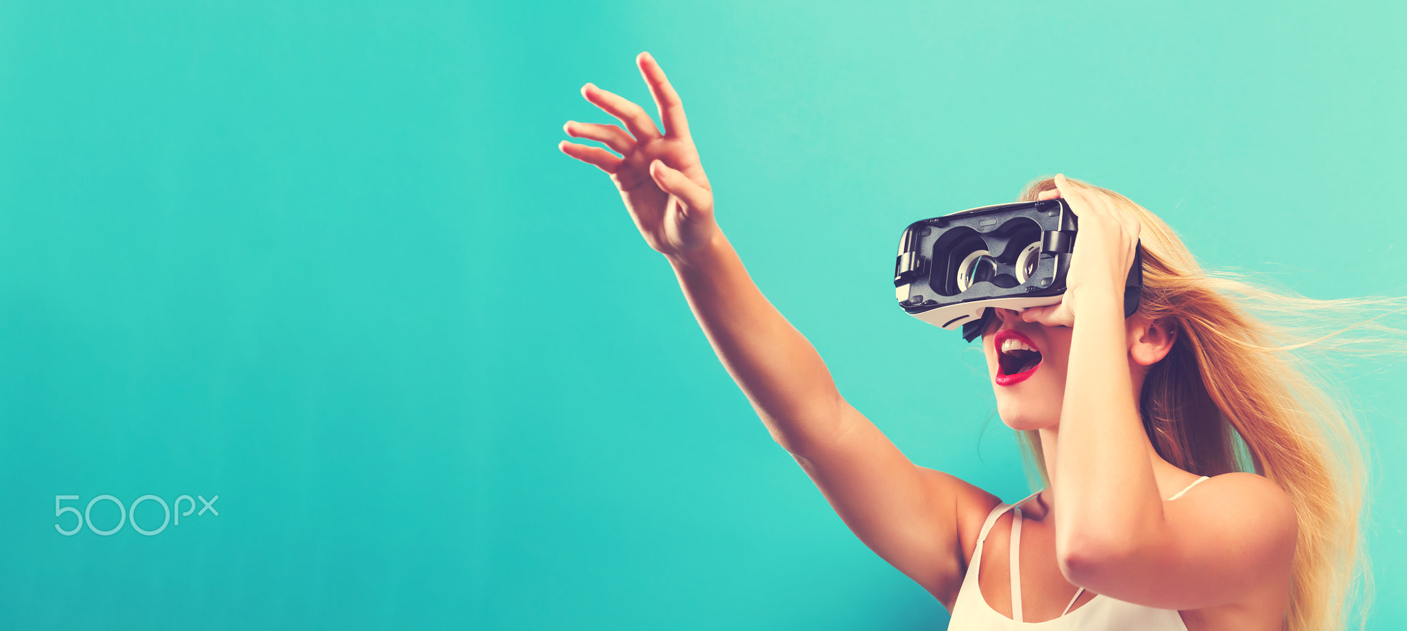 Young woman using virtual reality headset