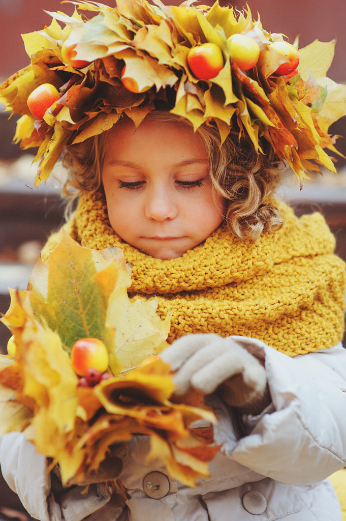 cute adorable toddler girl vertical portrait with bouquet of autumn leaves and wreath walking... by Maria Kovalevskaya on 500px.com