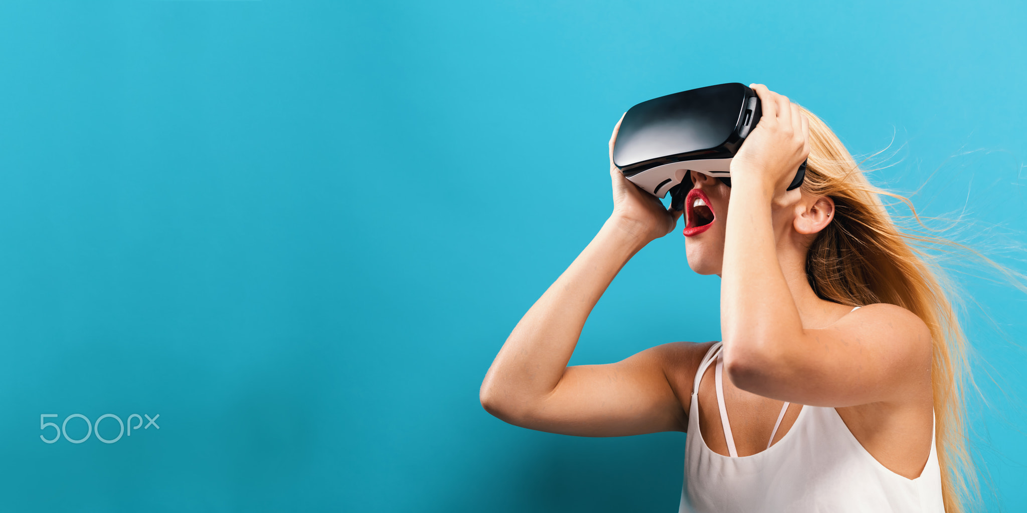 Young woman using virtual reality headset