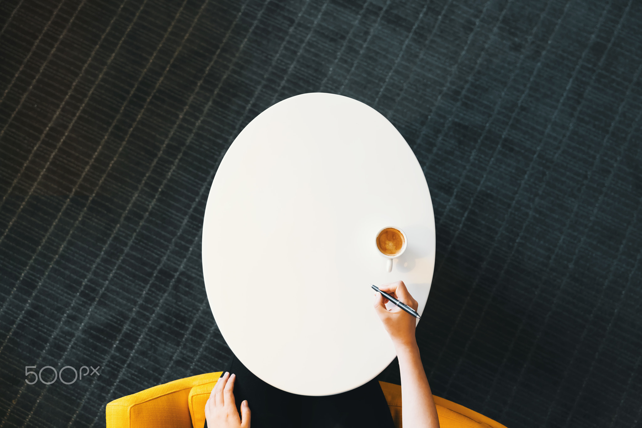 Overhead view of person using a pen