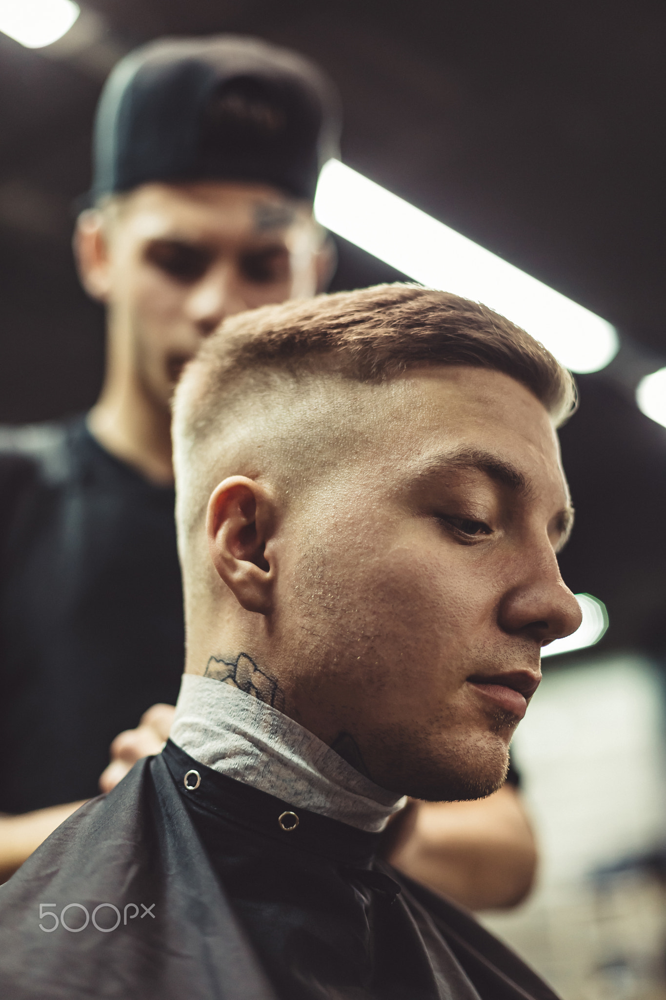 Anonymous barber preparing client