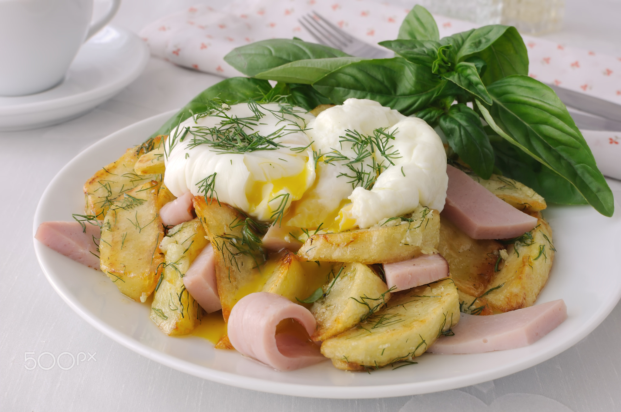 Fried potatoes with dill and ham with eggs Benedict