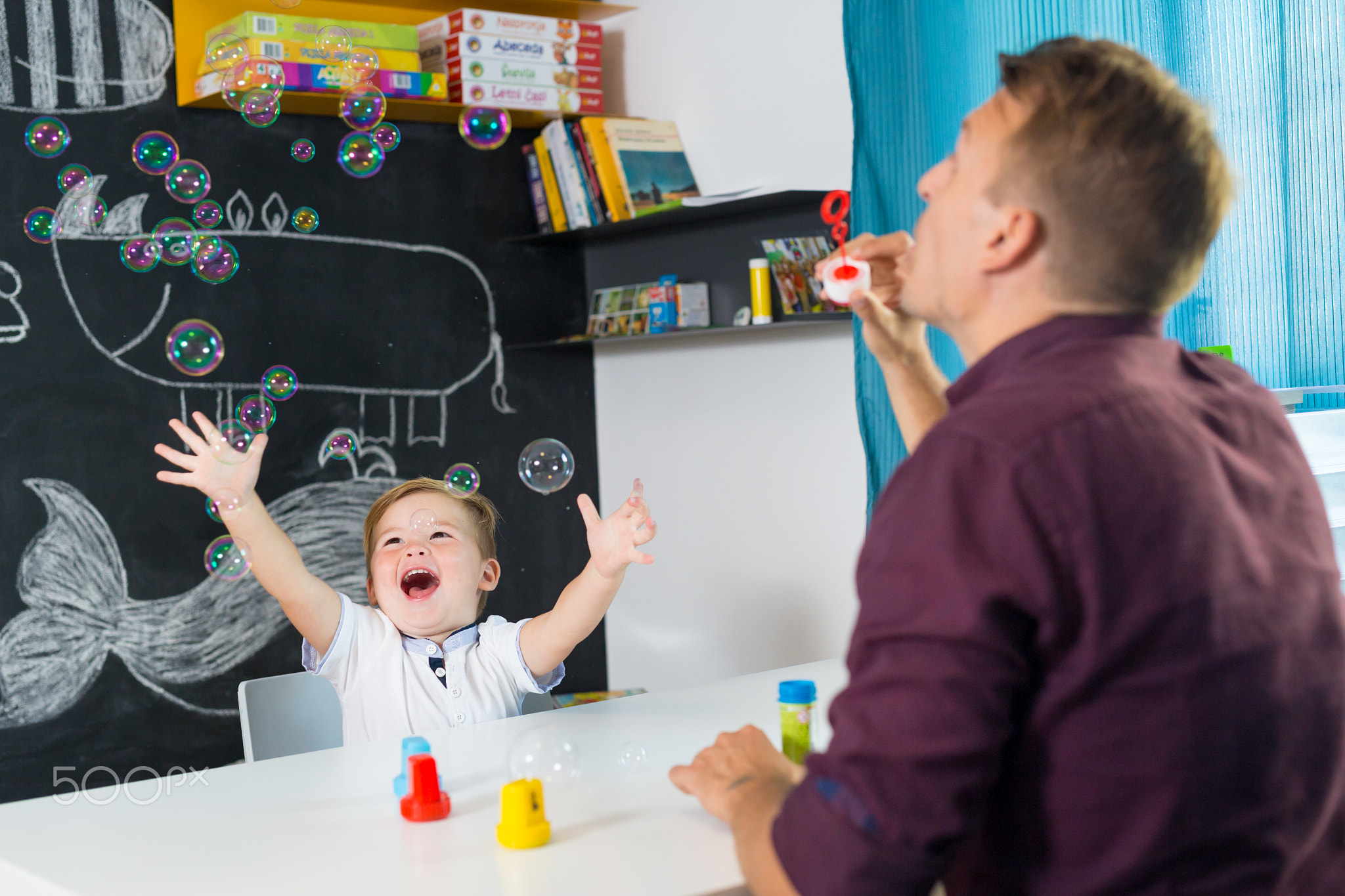 Cute little toddler boy at speechtherapist session.