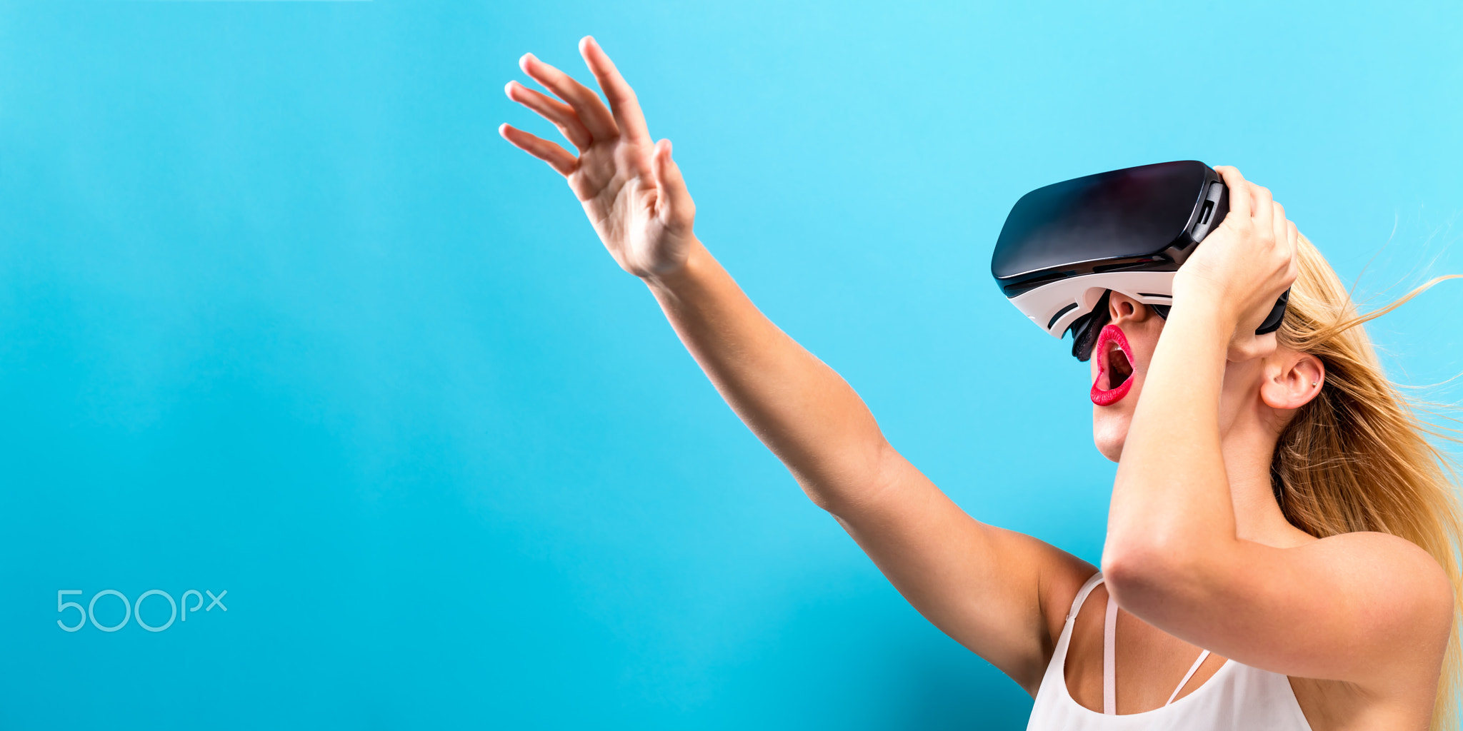 Young woman using virtual reality headset