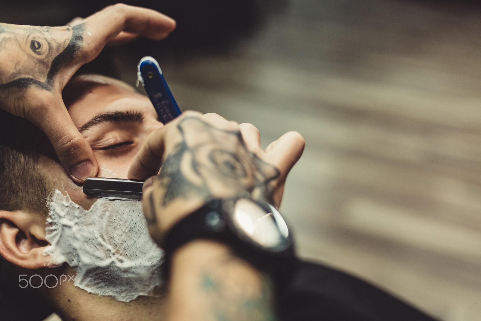Barber shaving client