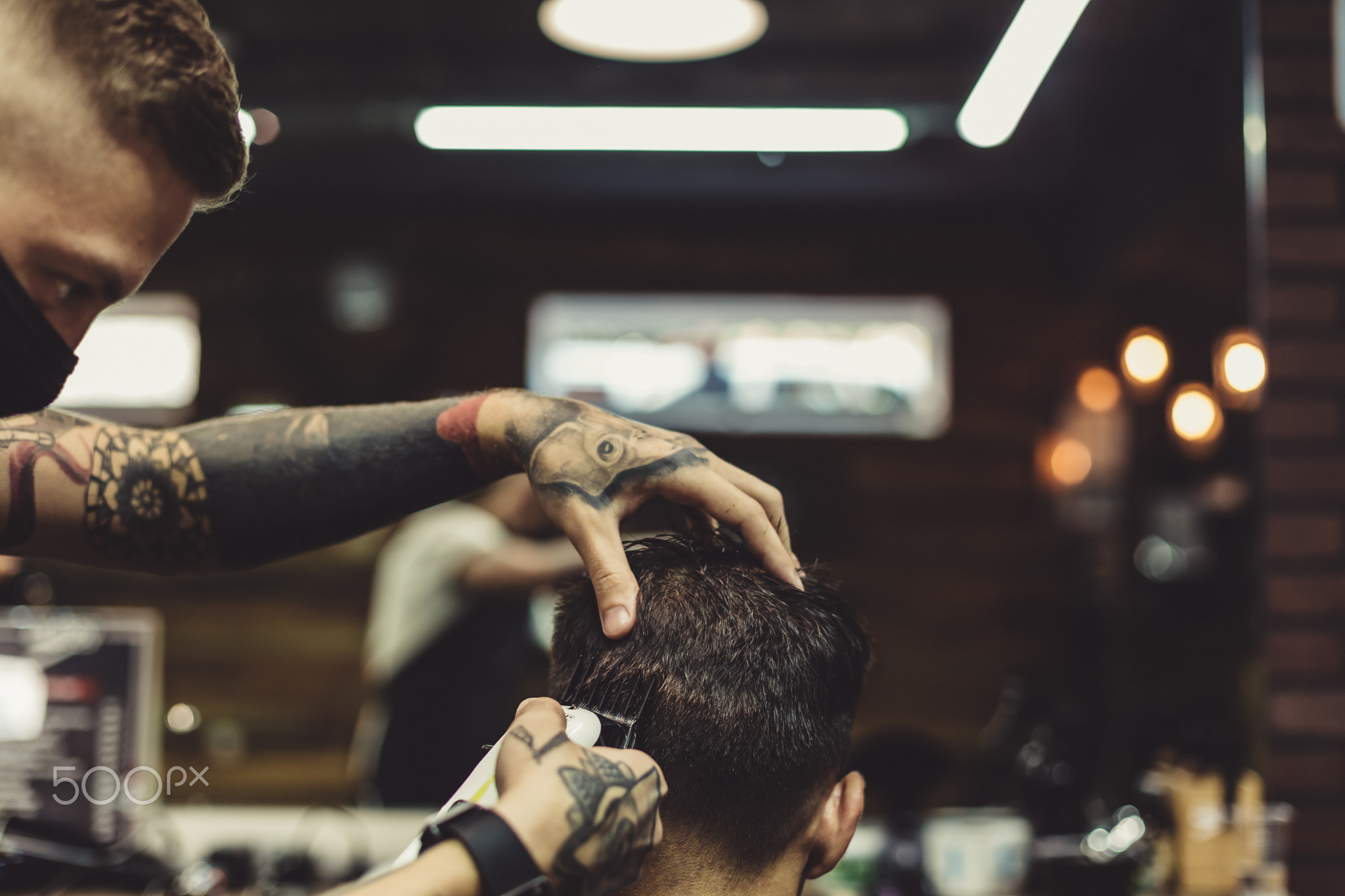 Barber shaving man in chair