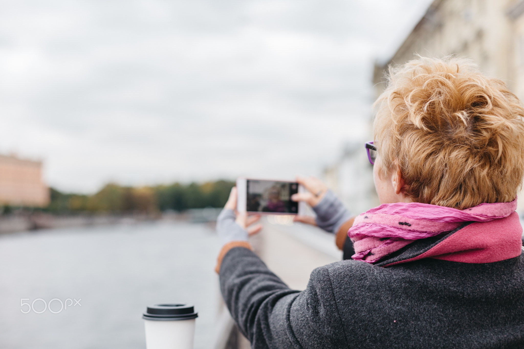 Woman taking shots from waterfront