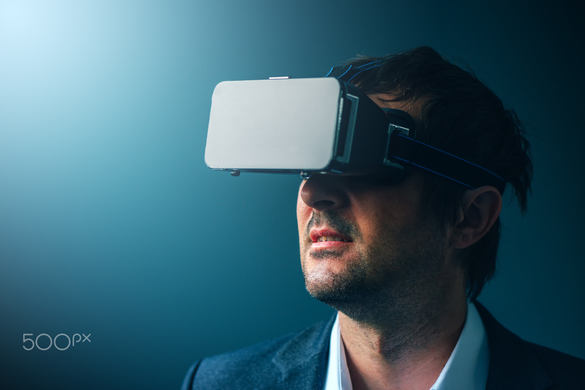 Businessman with VR goggles headset enjoying virtual reality