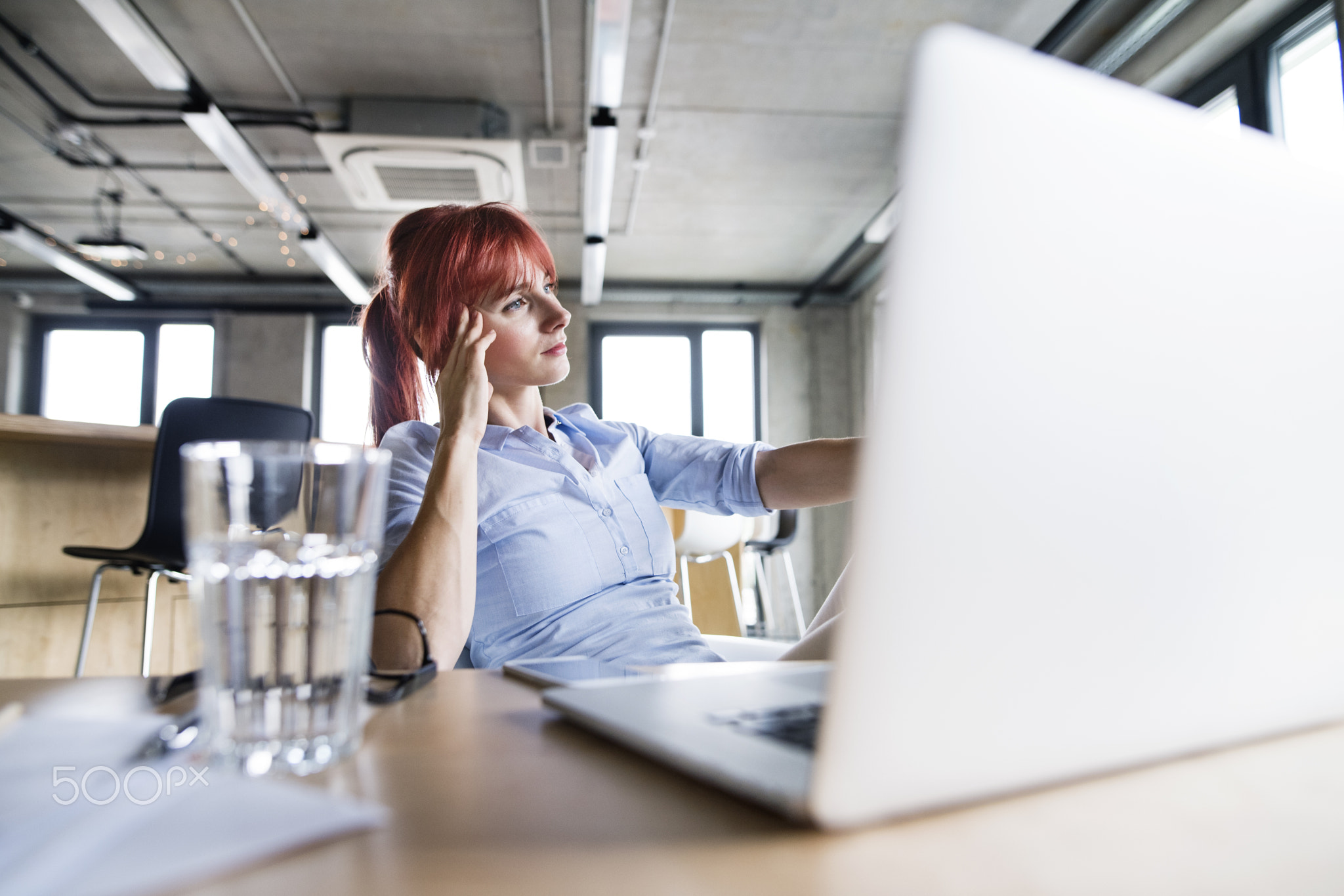 Businesswoman with laptop in her office.