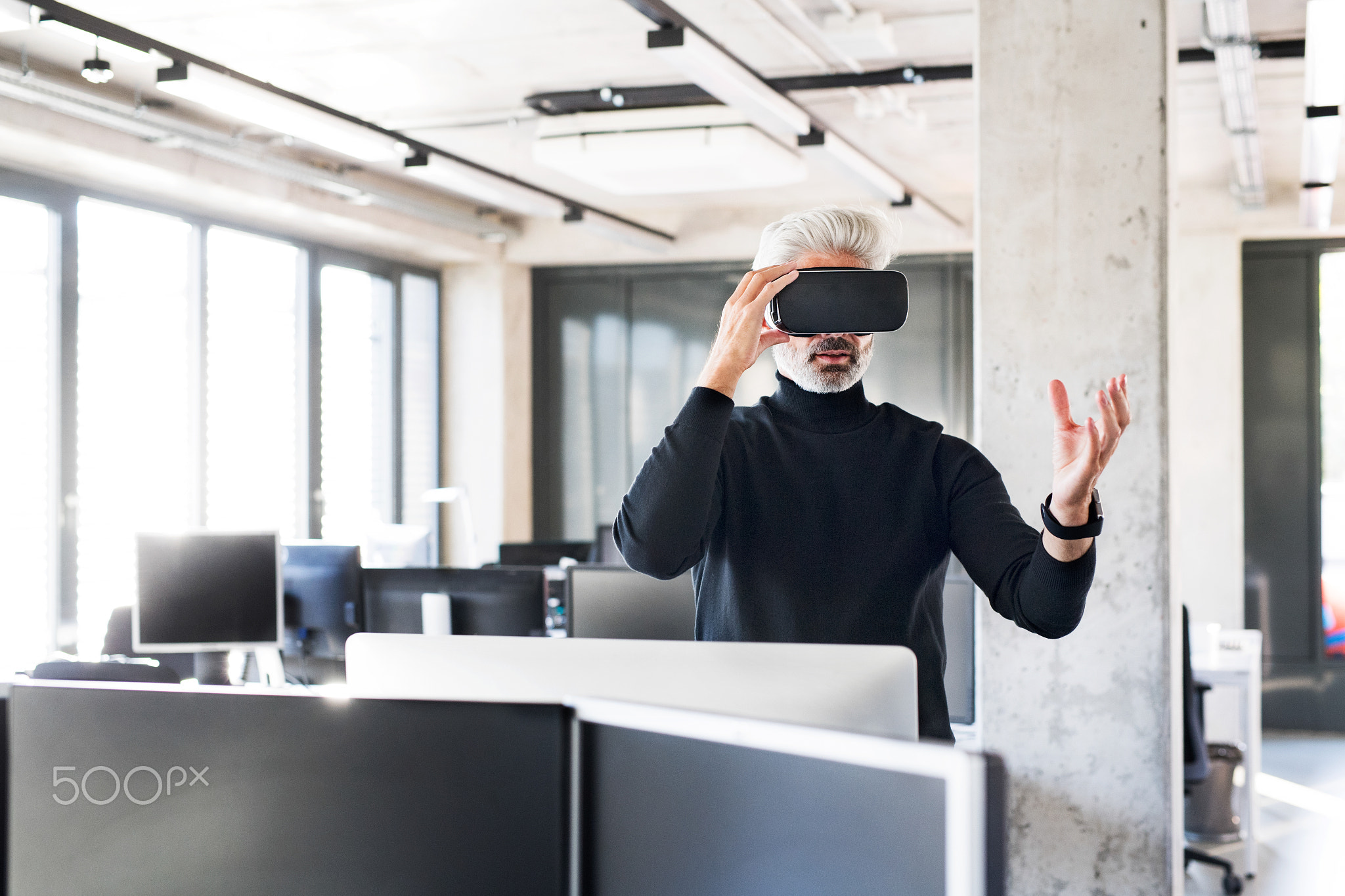 Mature businessman with tablet in the office.