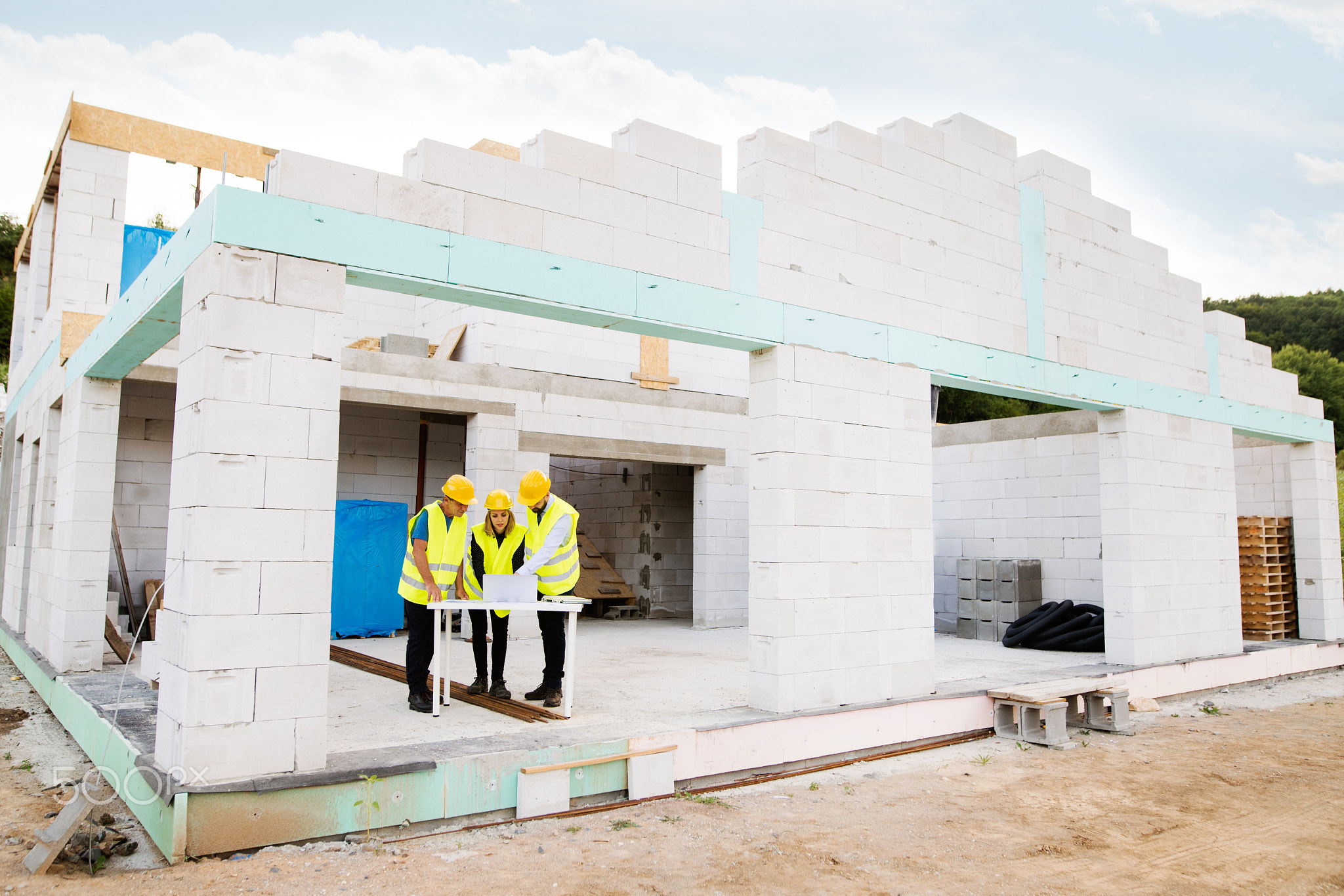 Architects and worker at the construction site.