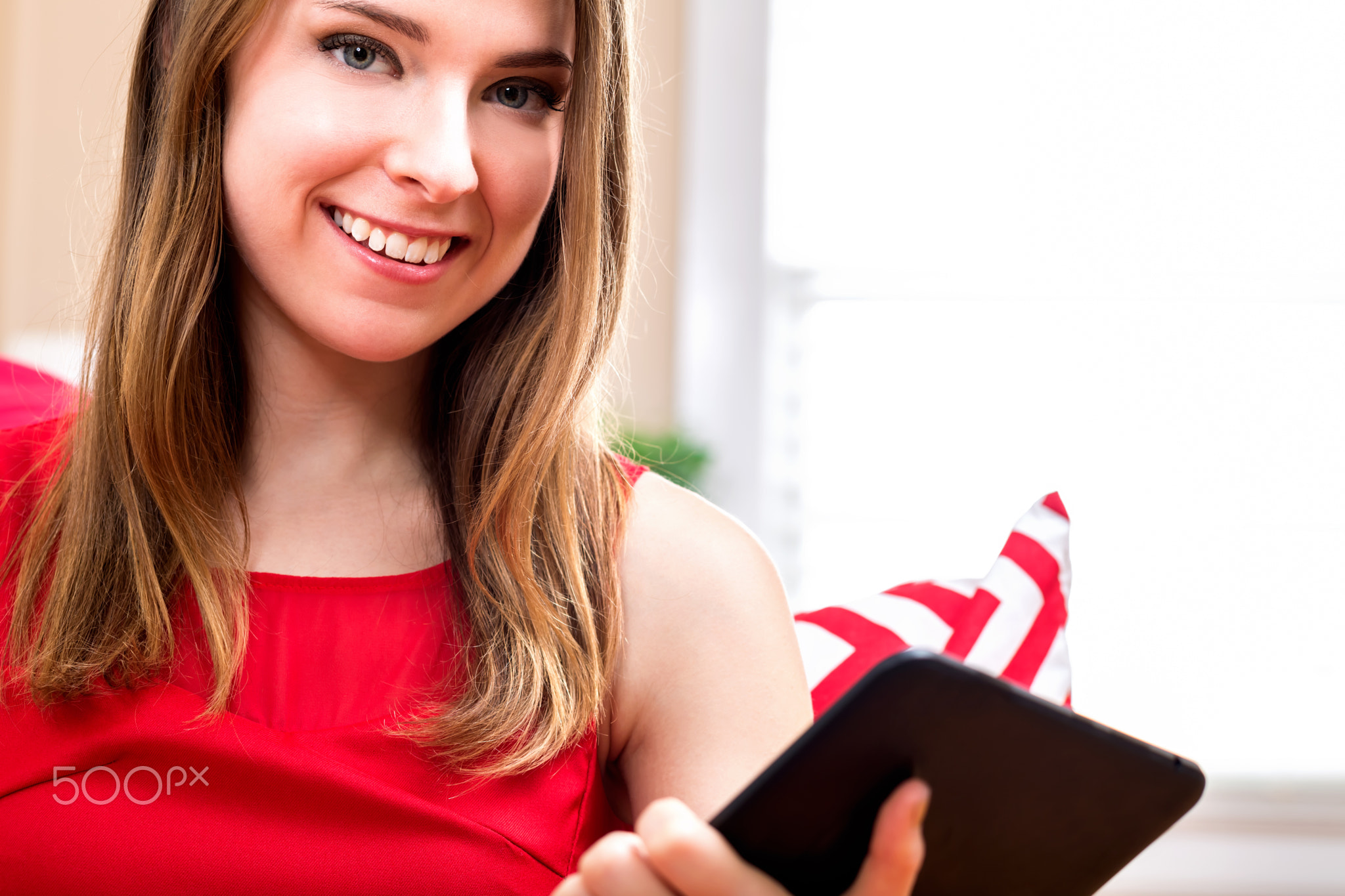 Young woman using her tablet at home