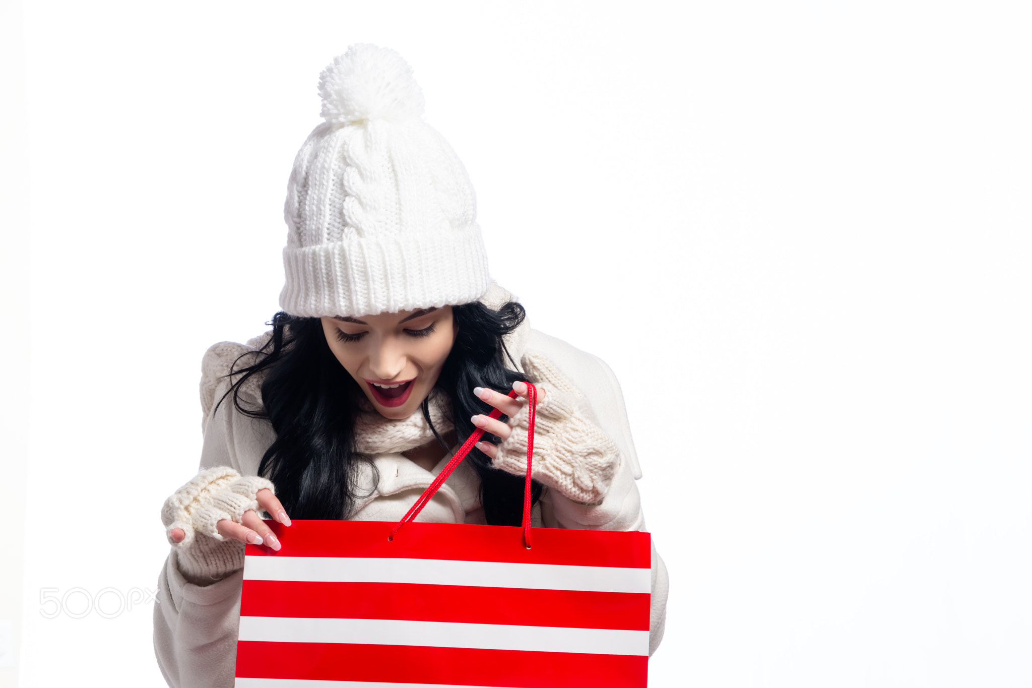 Happy young woman holding a shopping bag