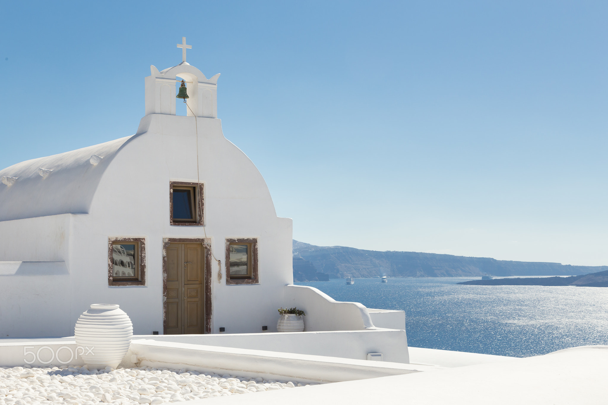 Traditional white orthodox church in Oia, Santorini, Greece.