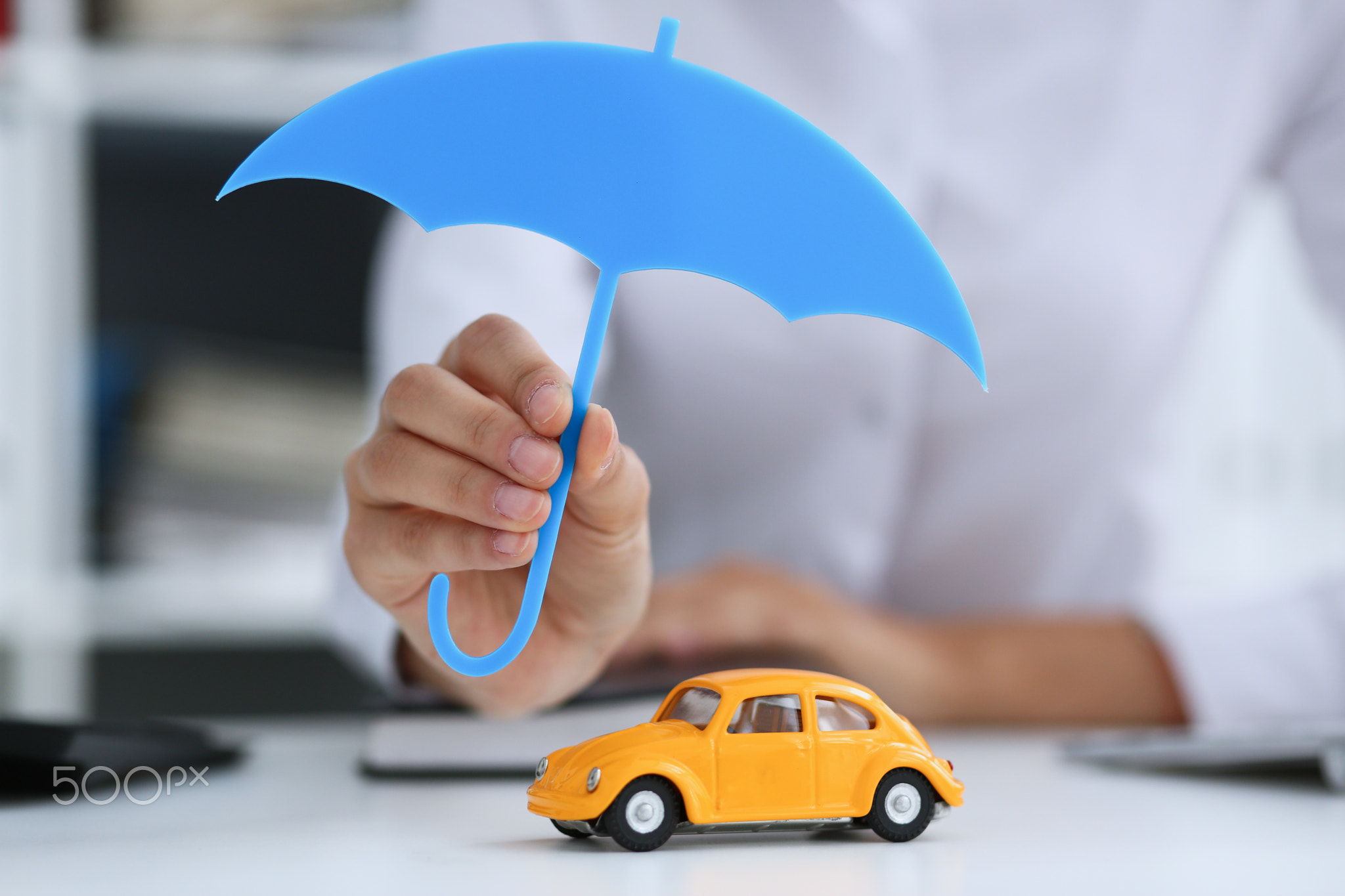 The female hand holds a miniature umbrella