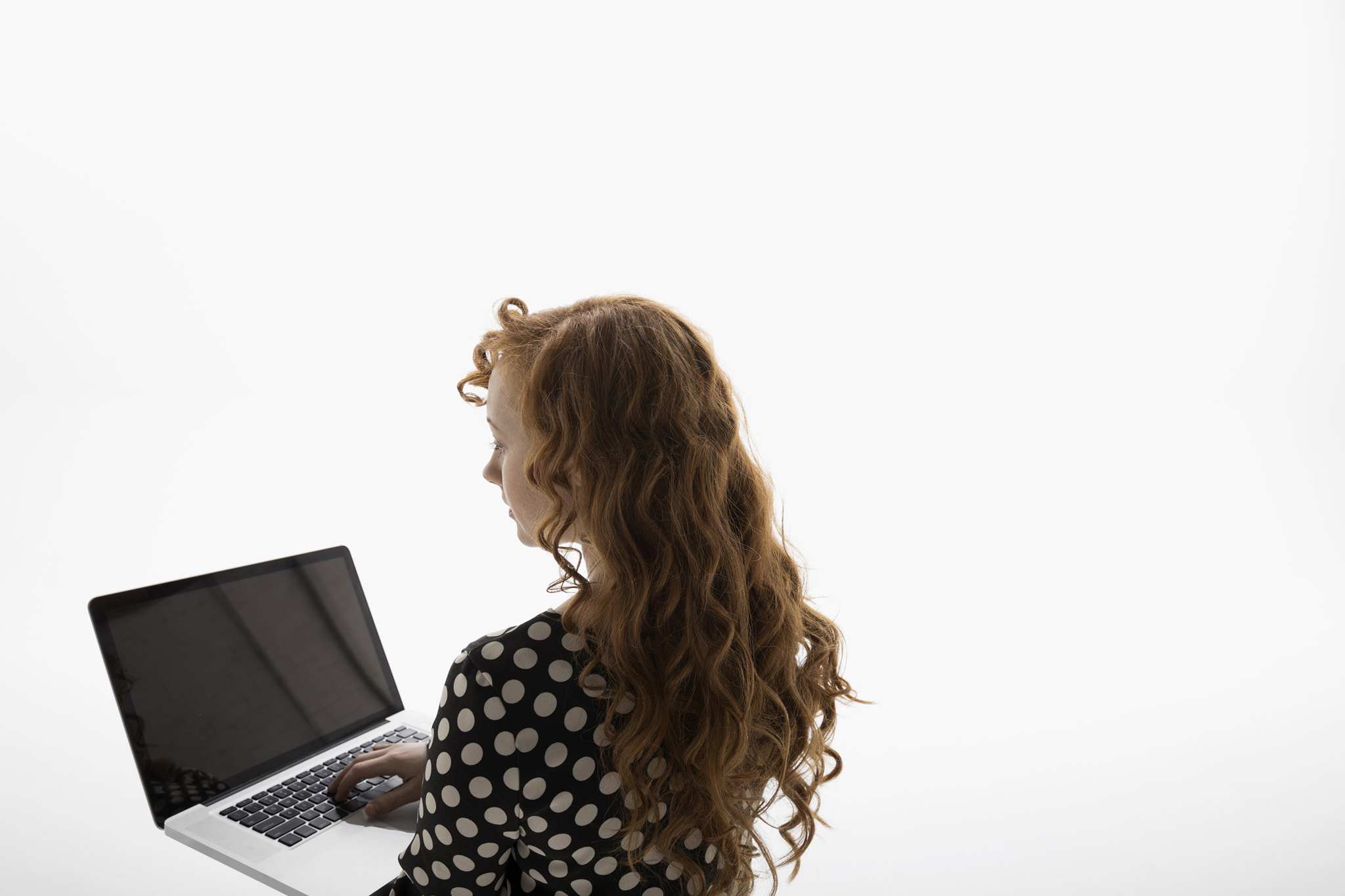 Businesswoman using laptop against white background