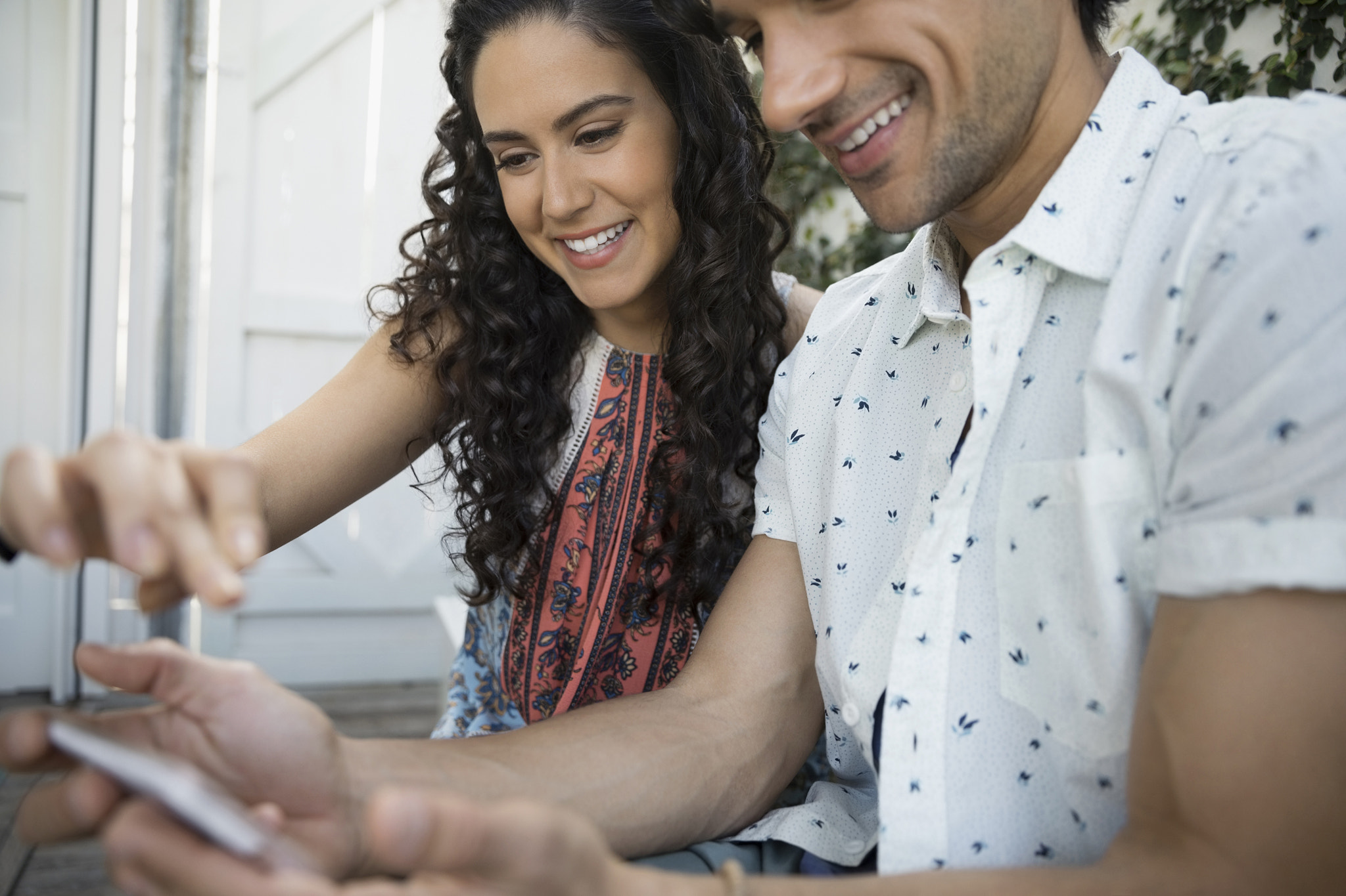 Smiling couple using smart phone