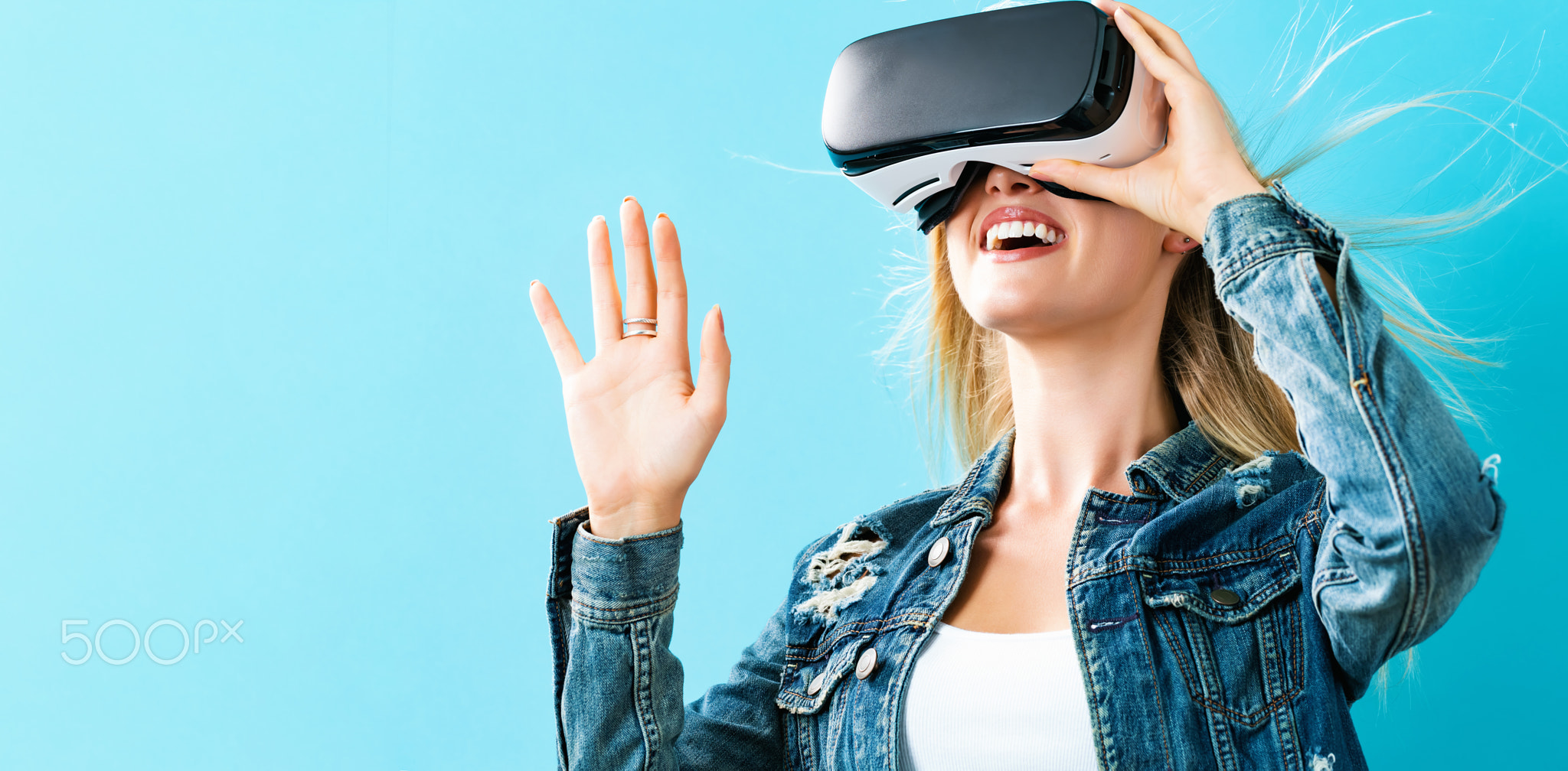 Young woman using virtual reality headset